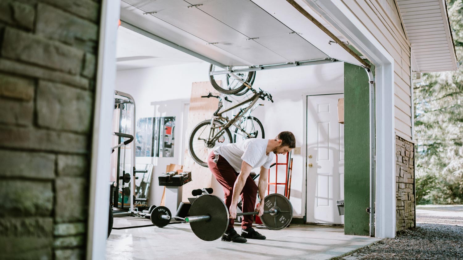 A man doing exercise in his garage