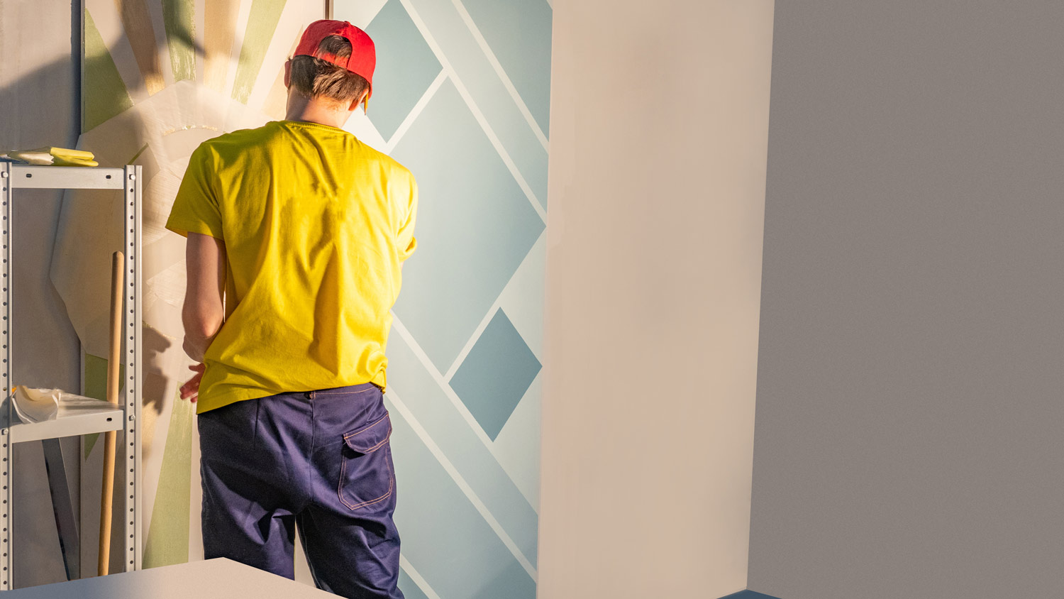 A man doing stencil in a room