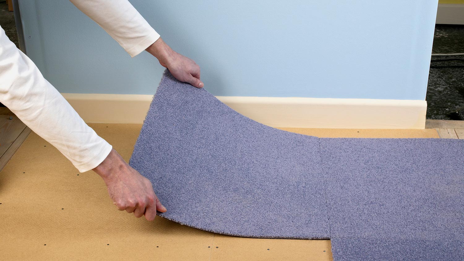 A man installing new carpet tiles