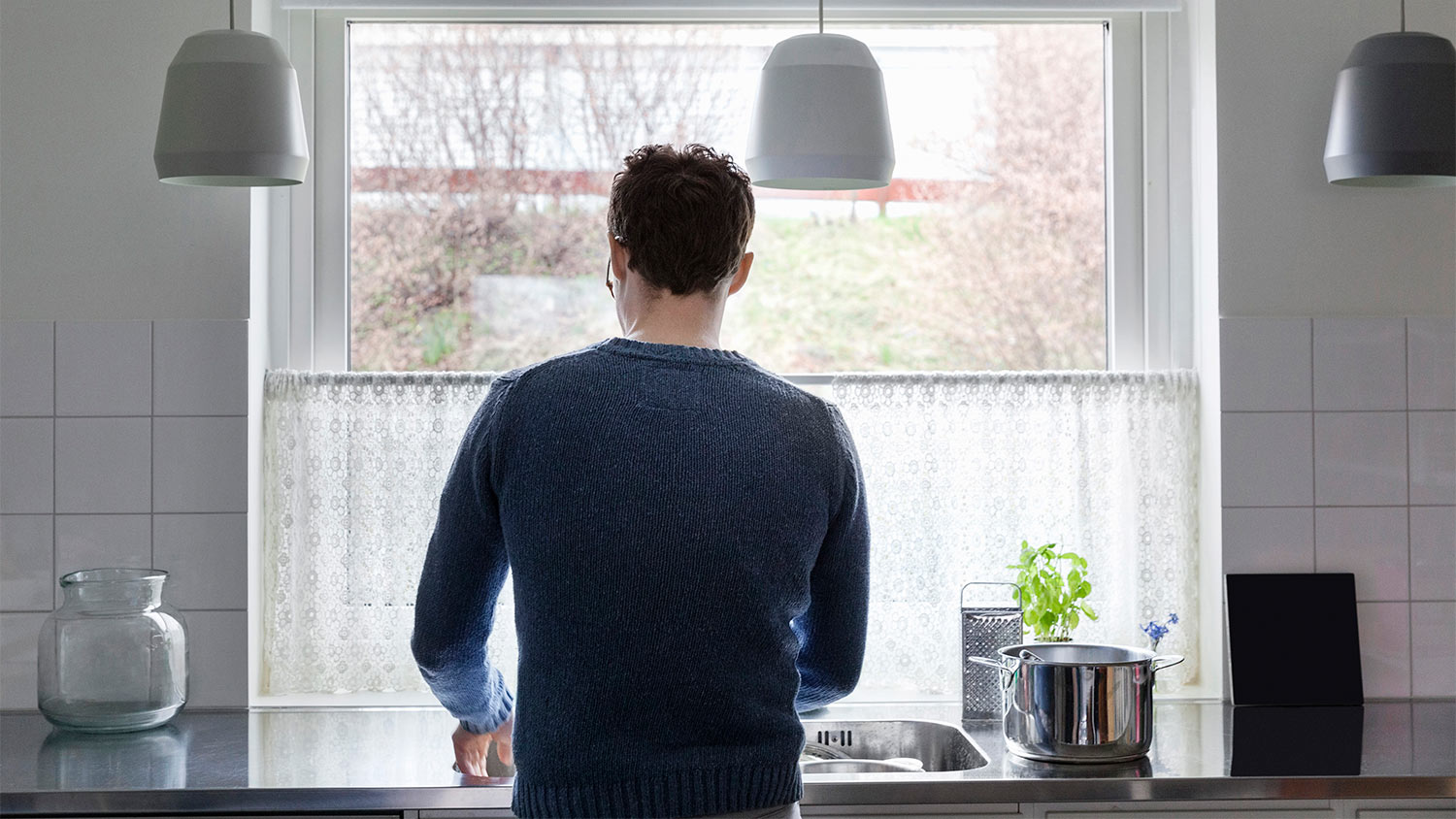 Man washing dishes at kitchen sink