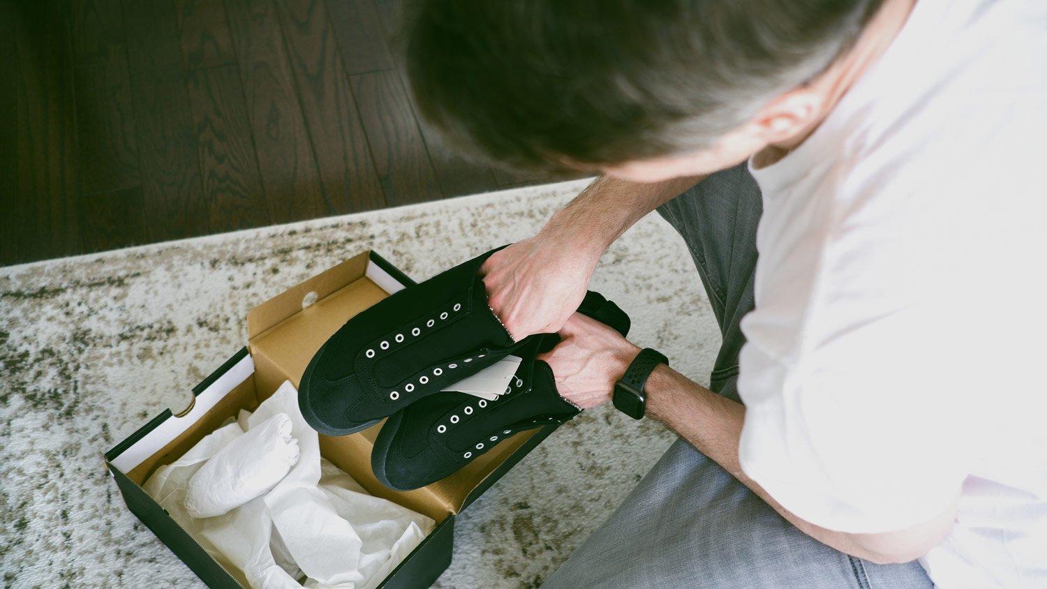 A man packing a pair of shoes