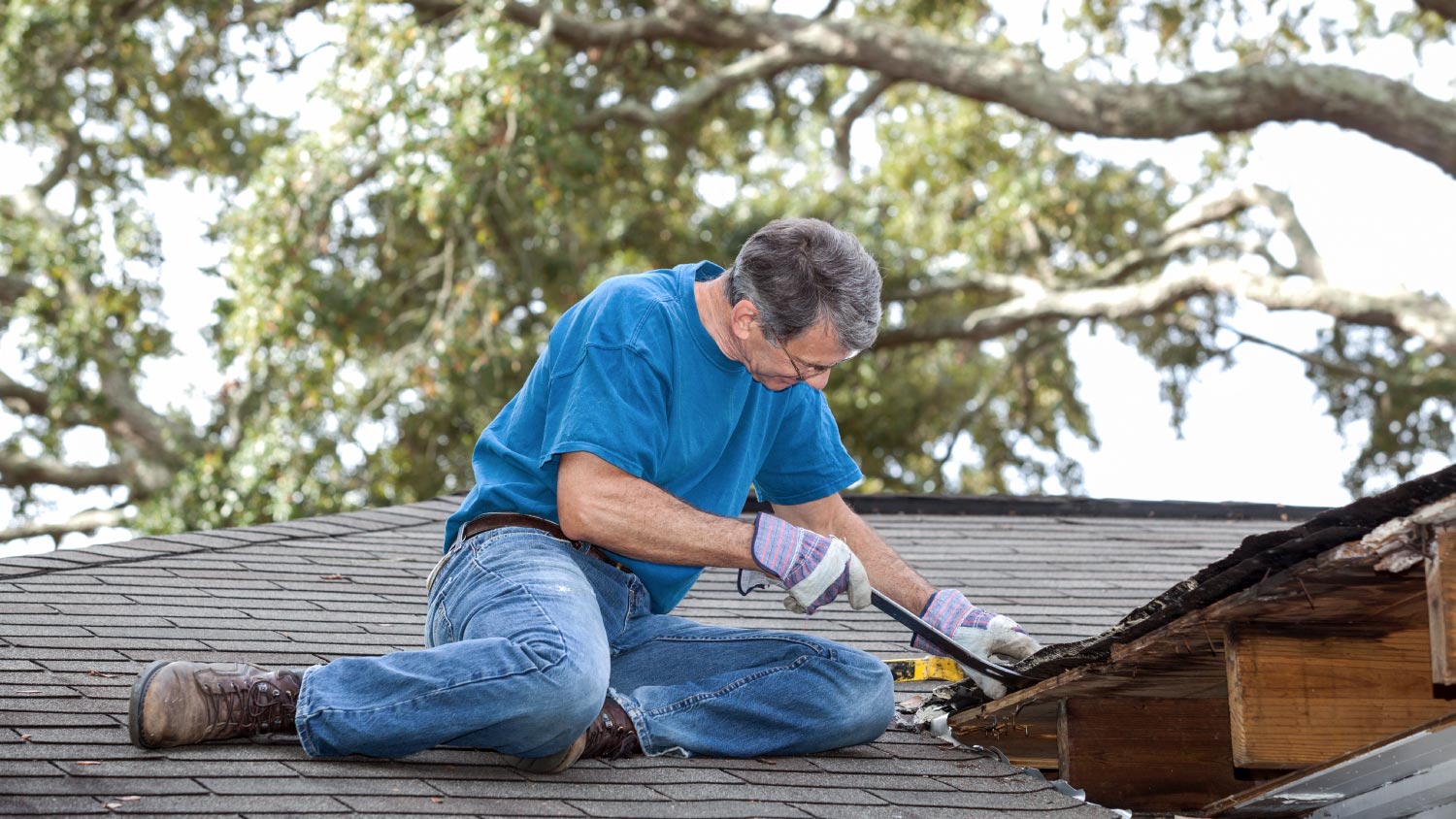 A man repairing leaking roof