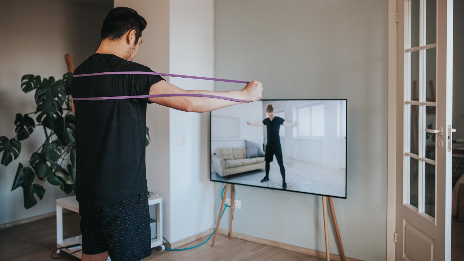 man working out in front of TV