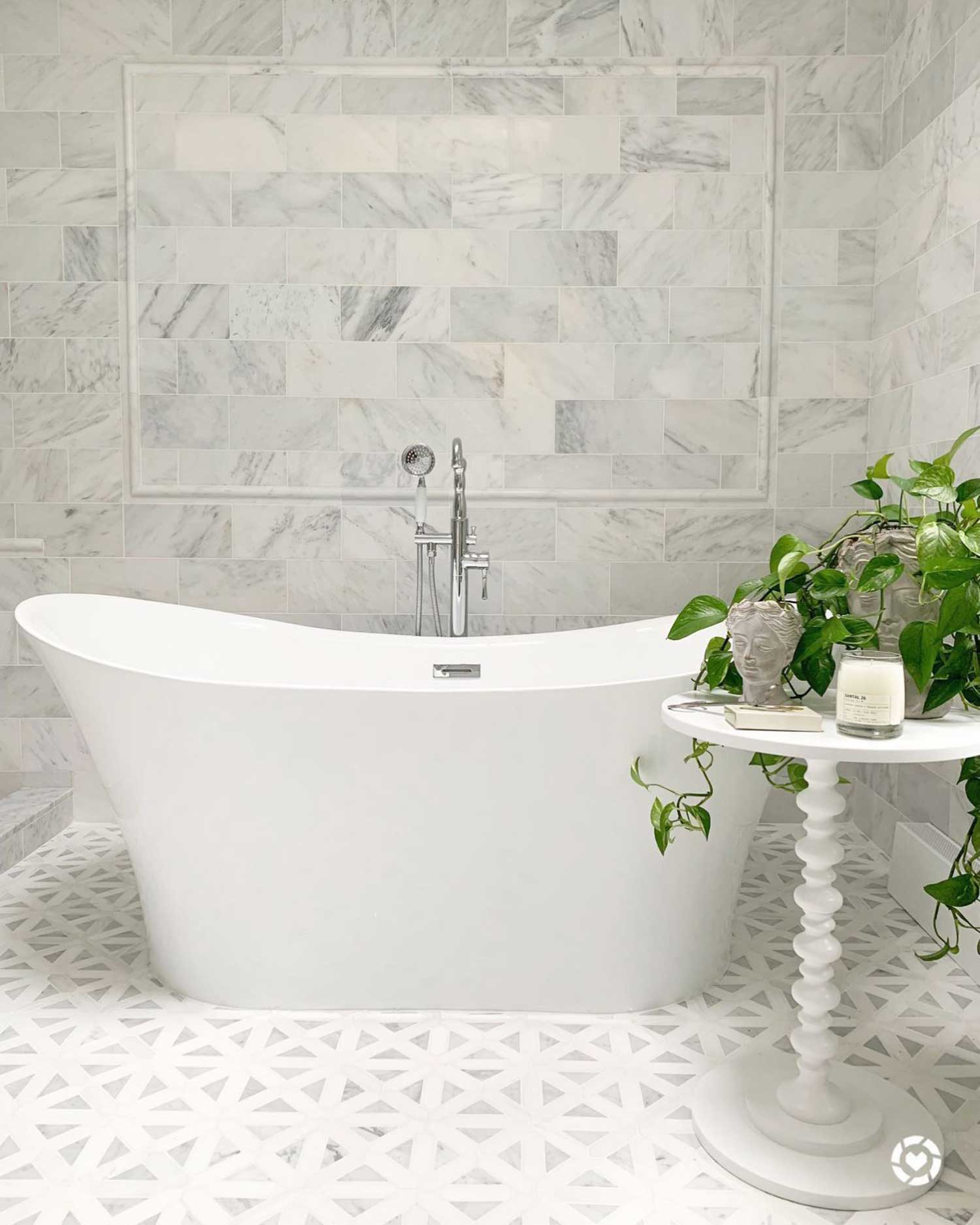 Luxurious bathroom with white marble tile and bathtub