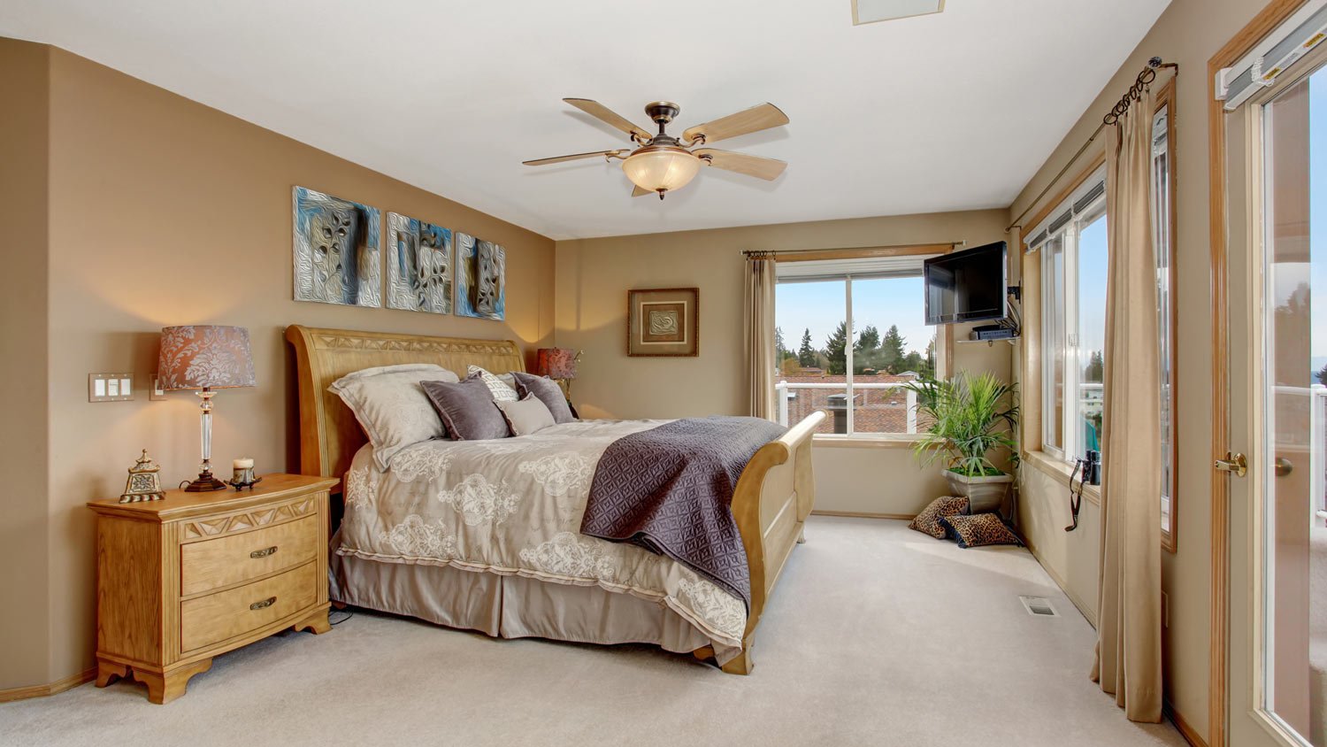 A master bedroom with wall-to-wall carpet