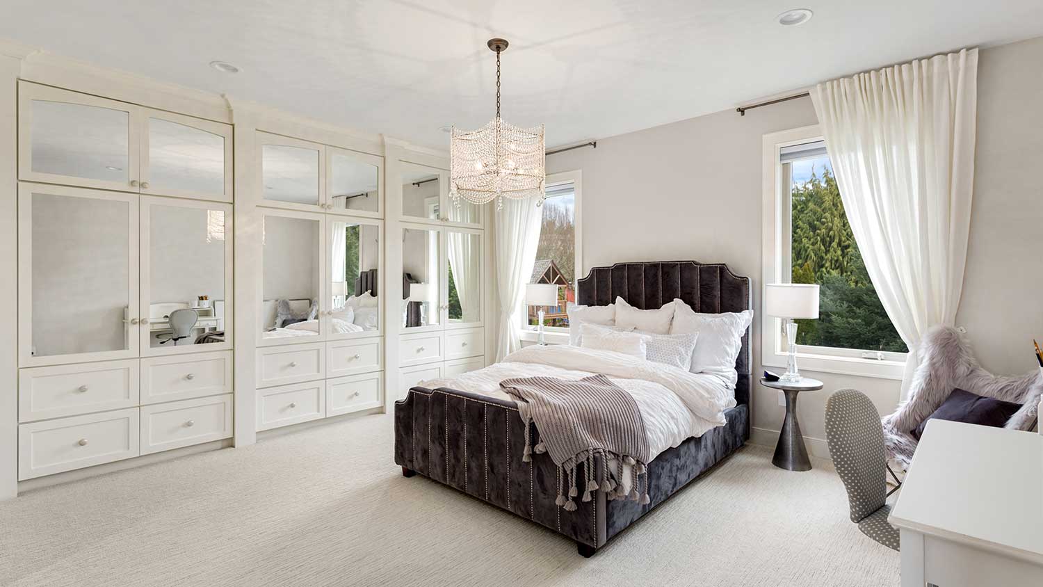 Master bedroom with large closet and chandelier
