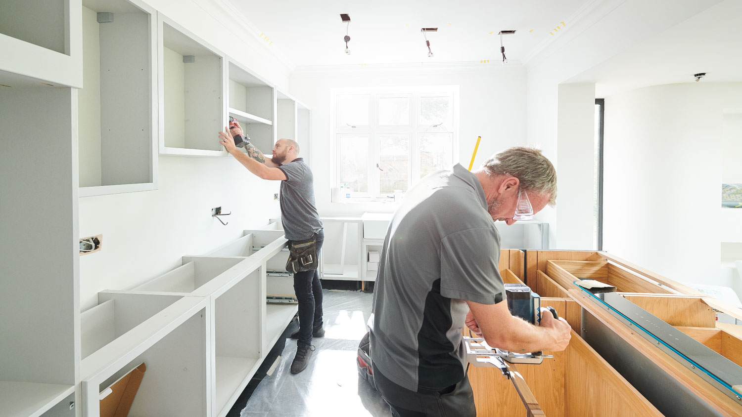 two contractors working on kitchen construction