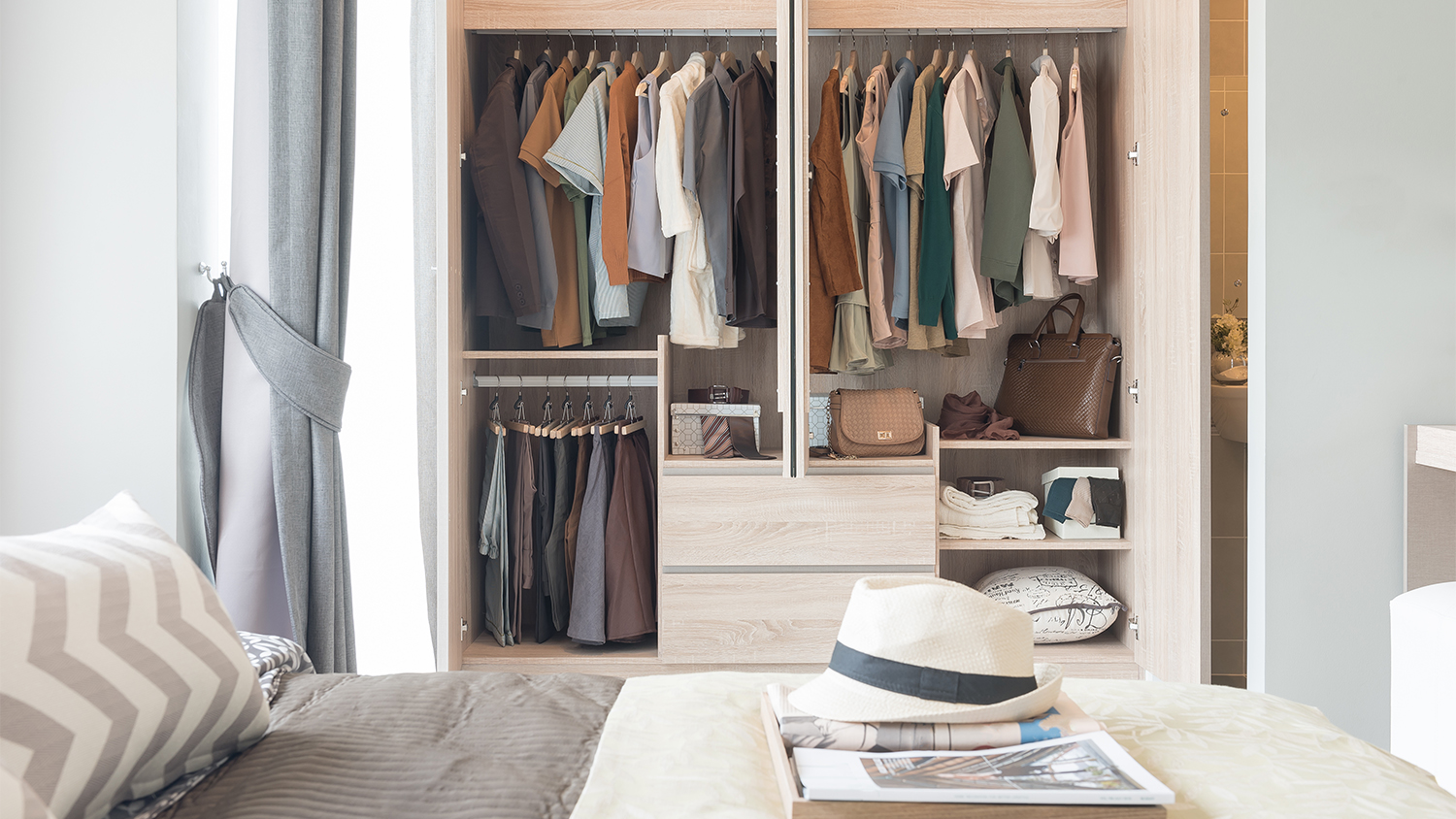 organized clothes hanging in mens closet