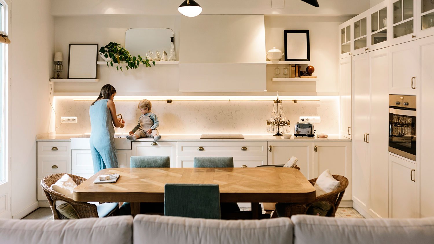 A mother with her son in a kitchen with hidden lighting