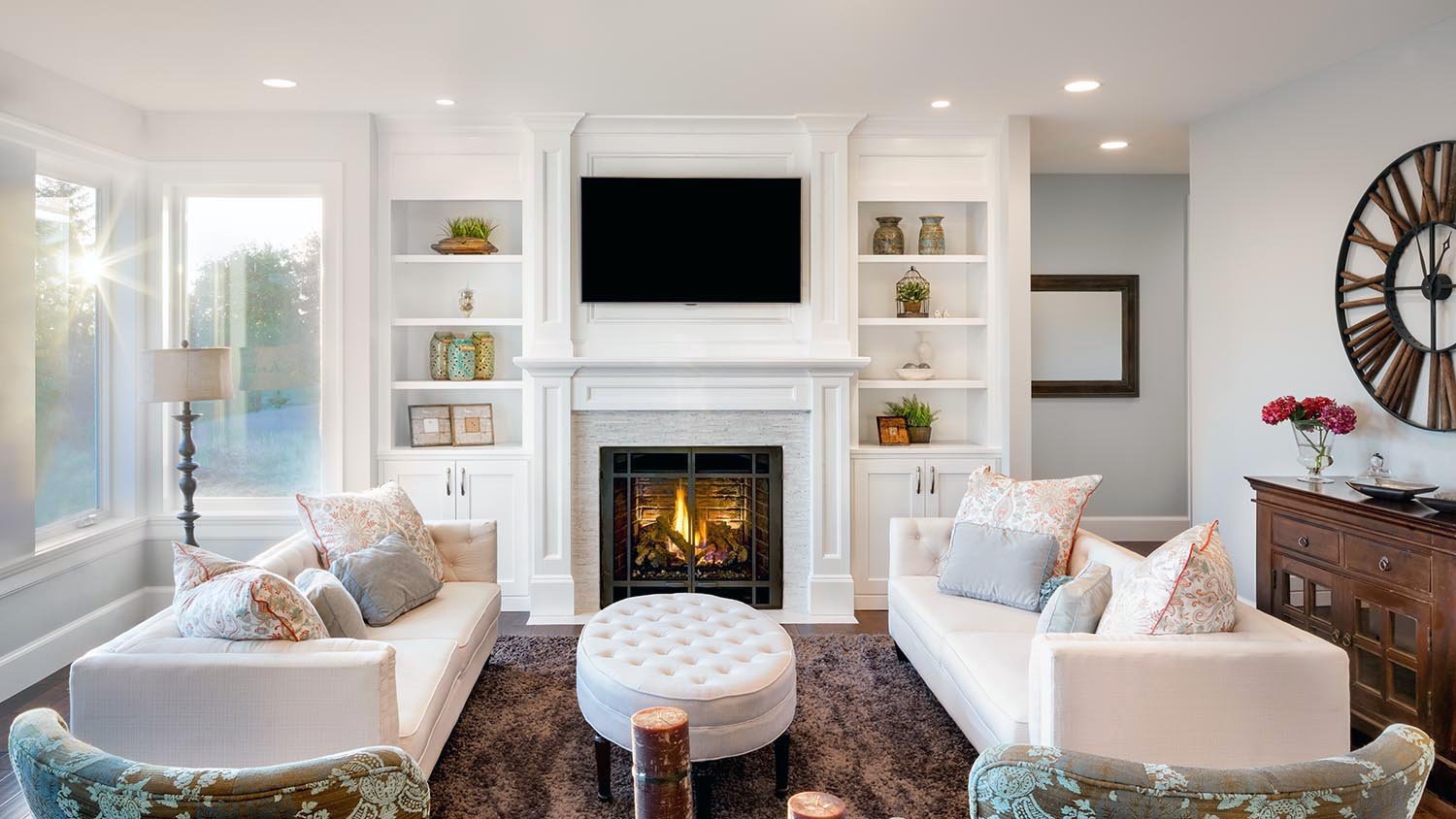 living room with tv mounted over fireplace