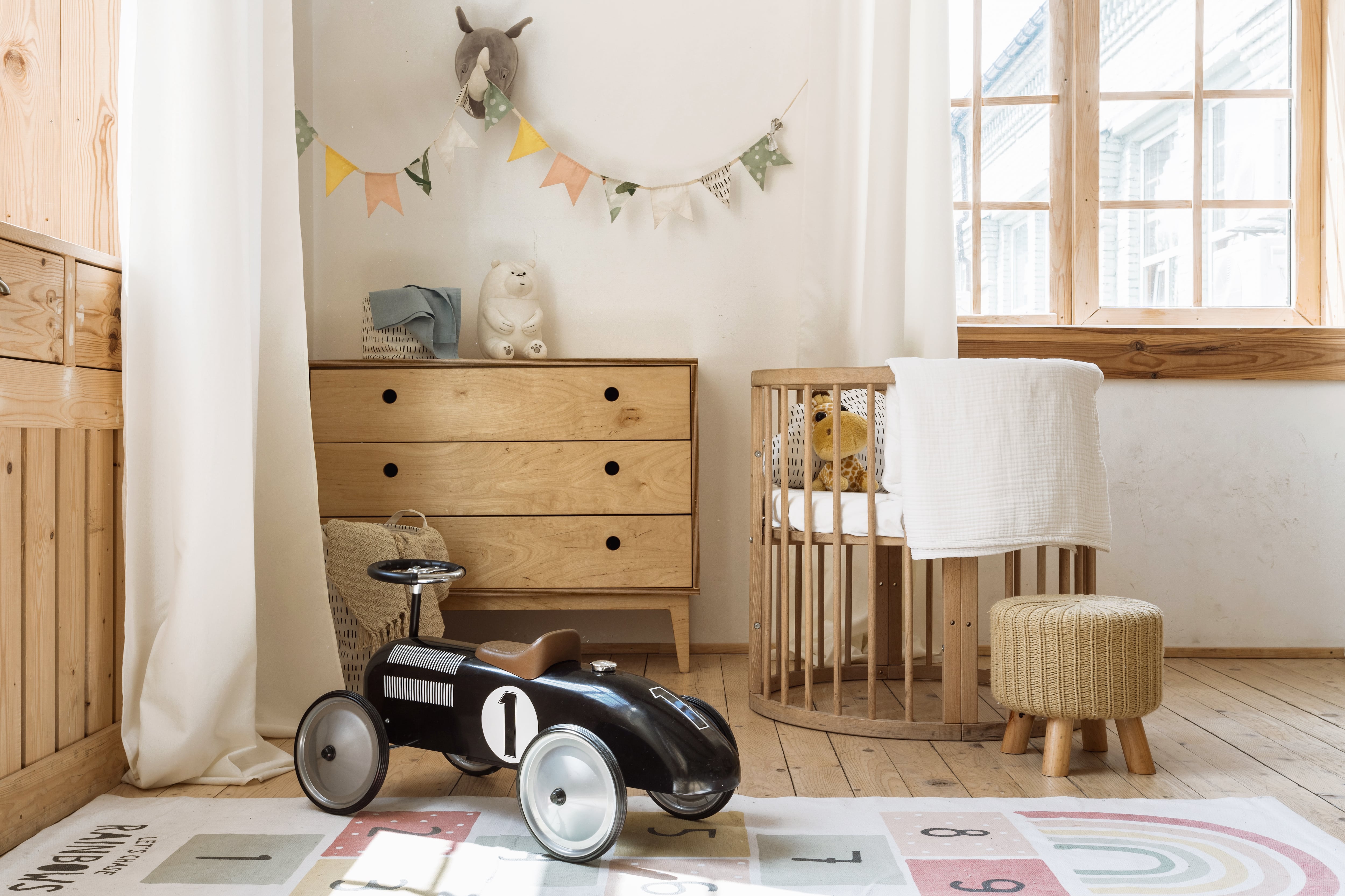 Nursery with wood accents and hopscotch-style rug