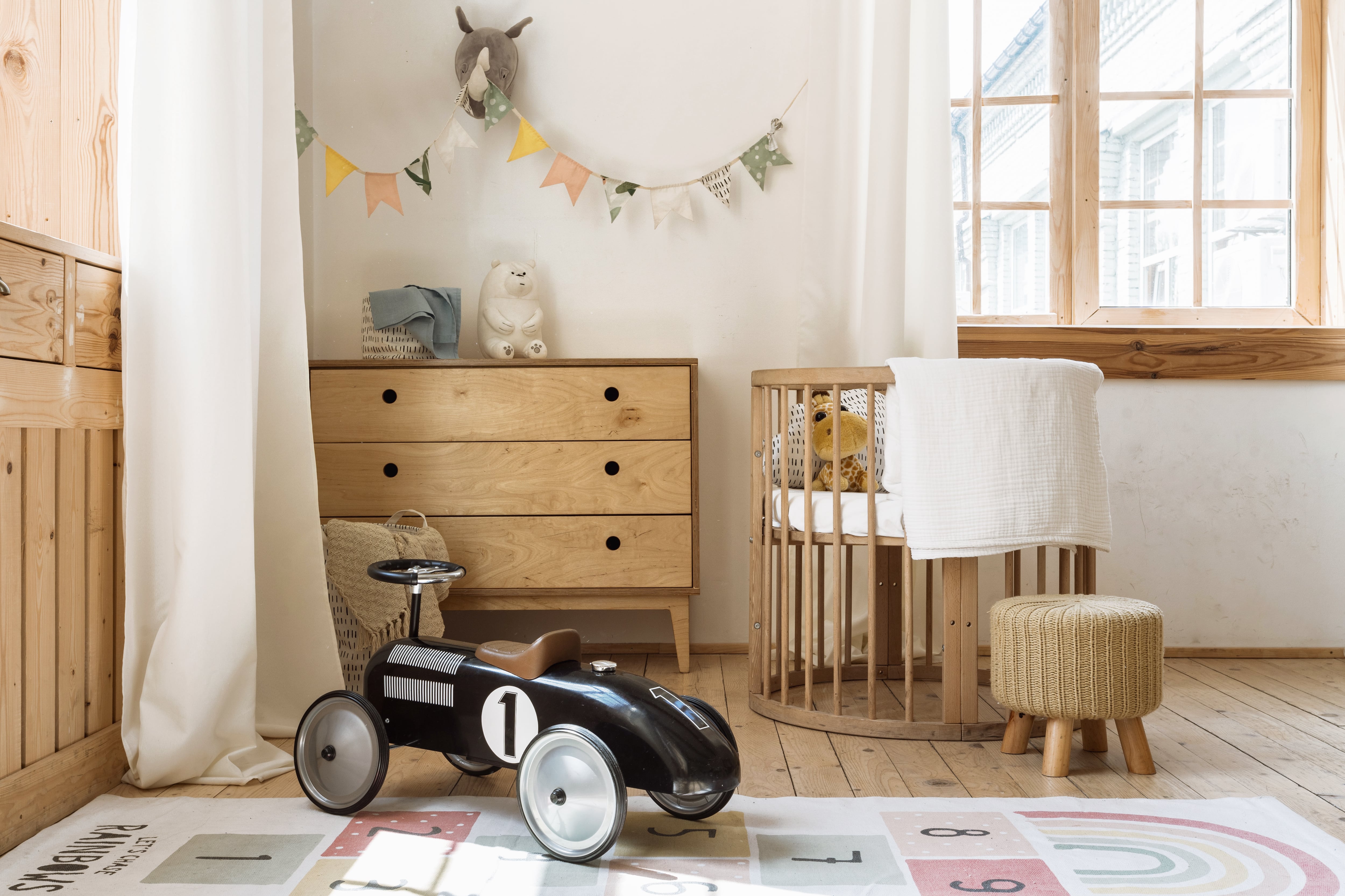 Nursery with wood accents and hopscotch-style rug 