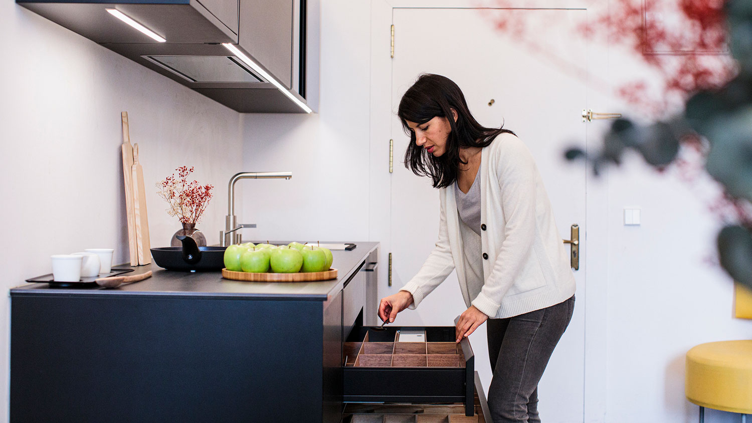 Woman opening kitchen drawer