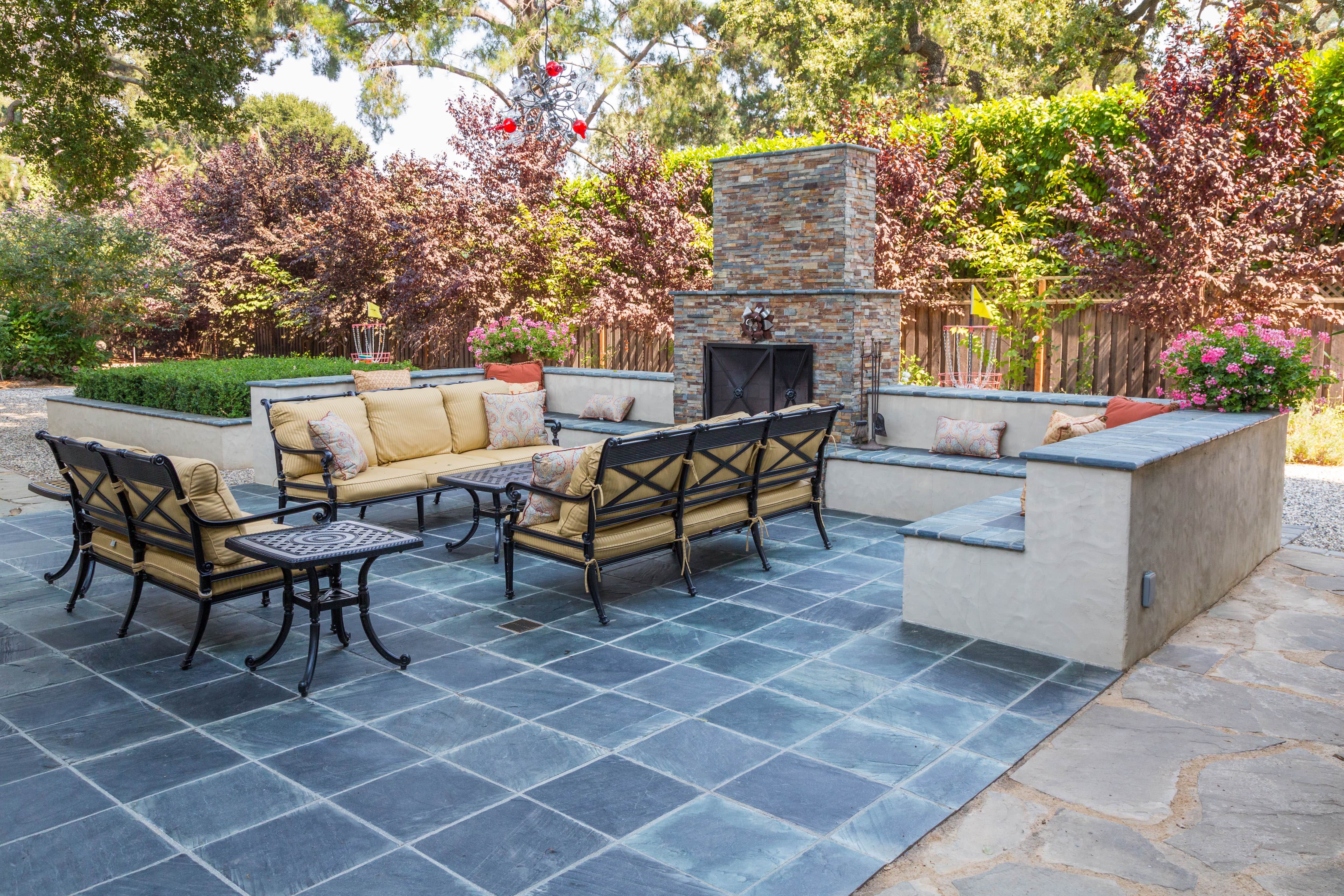 Outdoor patio set in front of stone fireplace