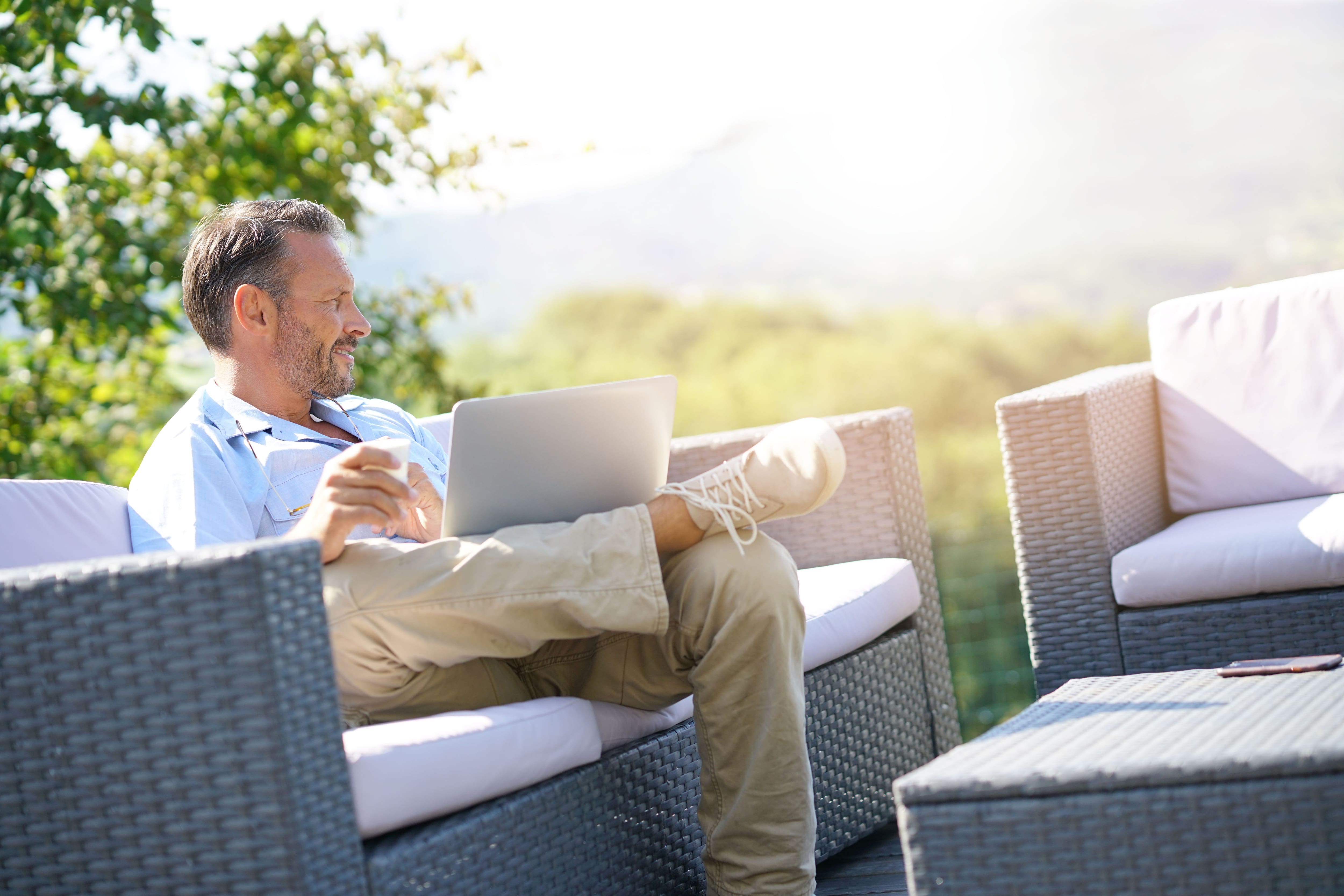 Man sitting on outdoor wicker patio set