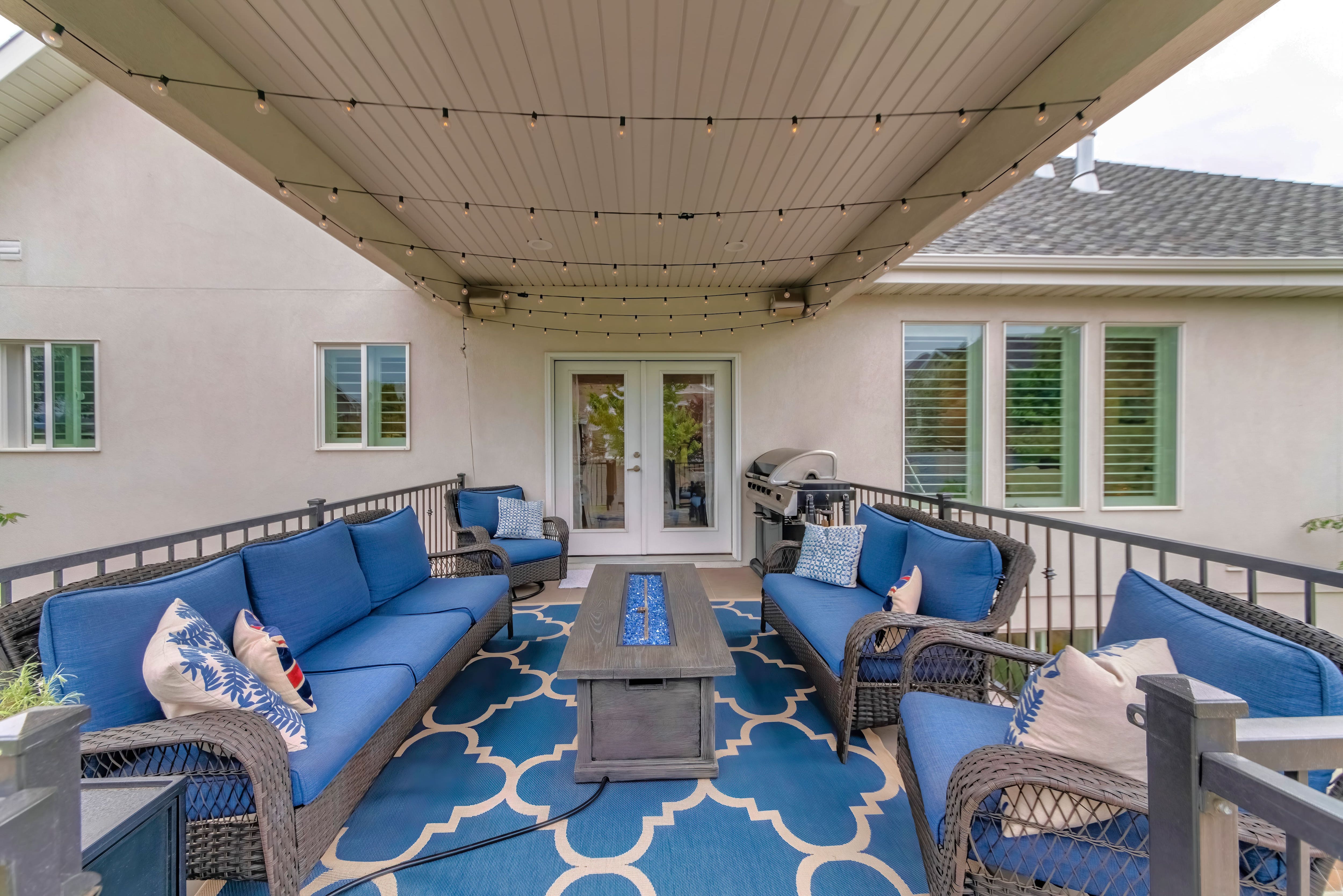 Patio with outdoor furniture, fire pit, and string lights 