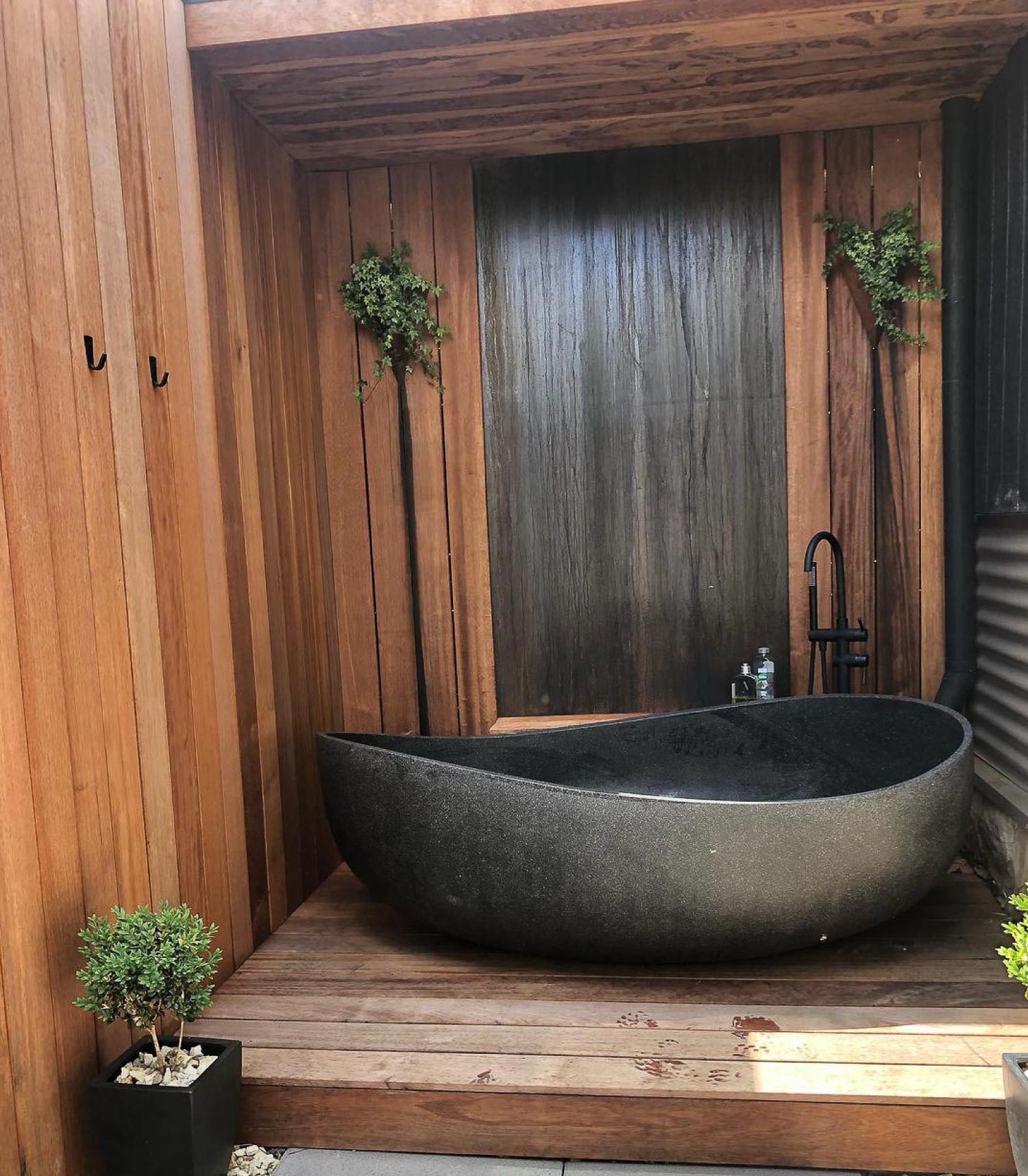 An outdoor wooden bathroom