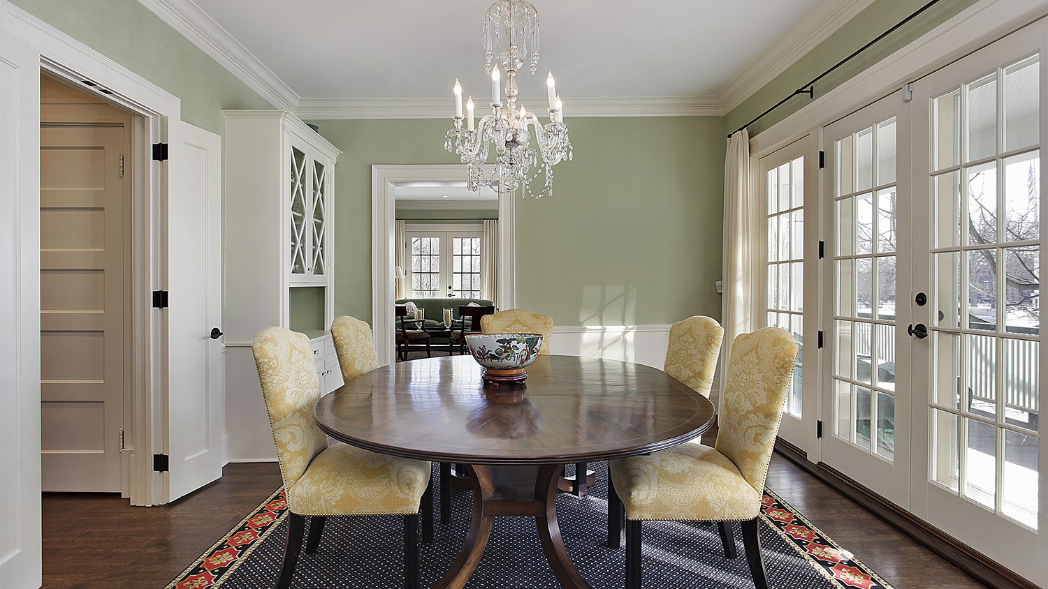 green dining room with blue rug  