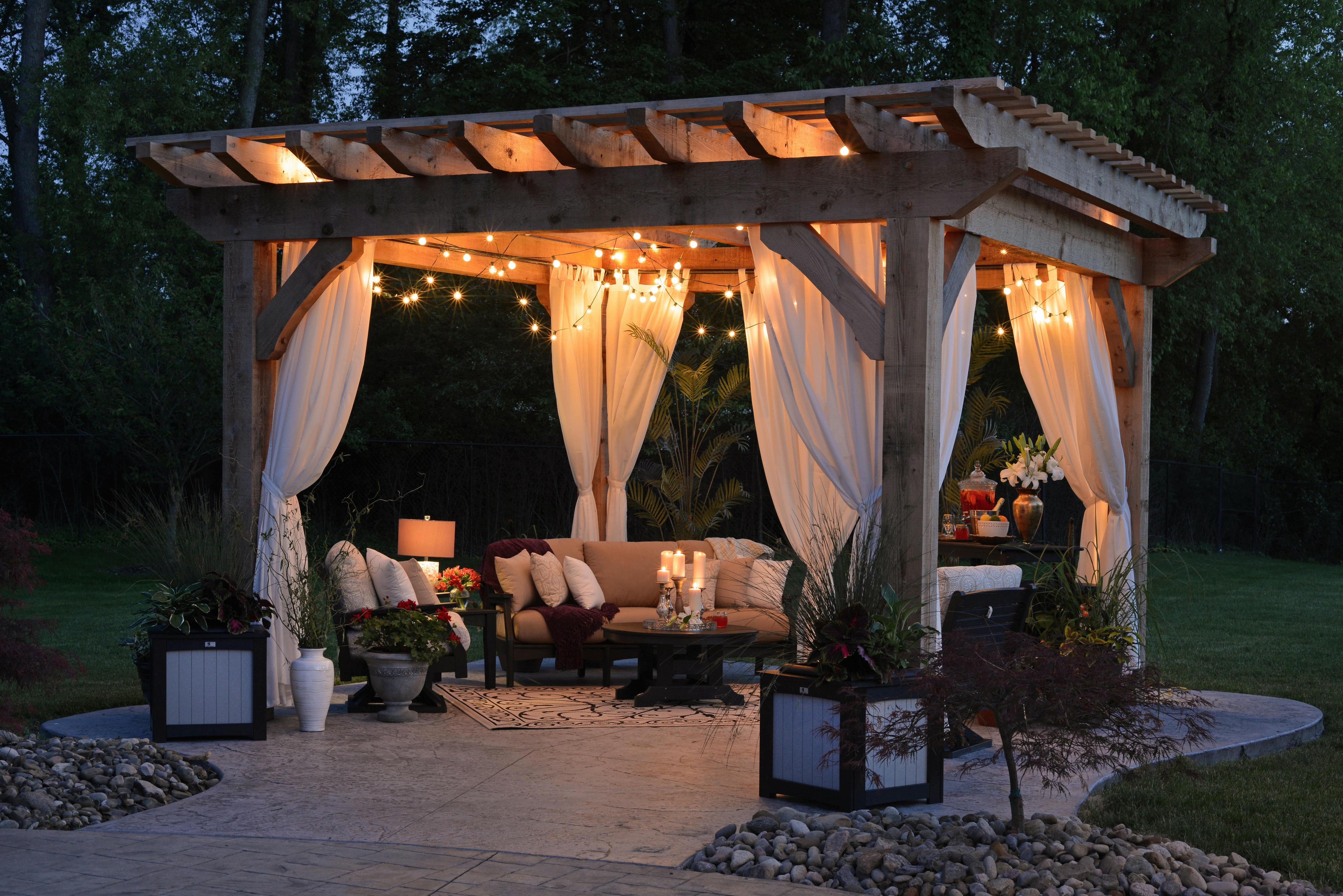 Pergola on a stone patio with string lights