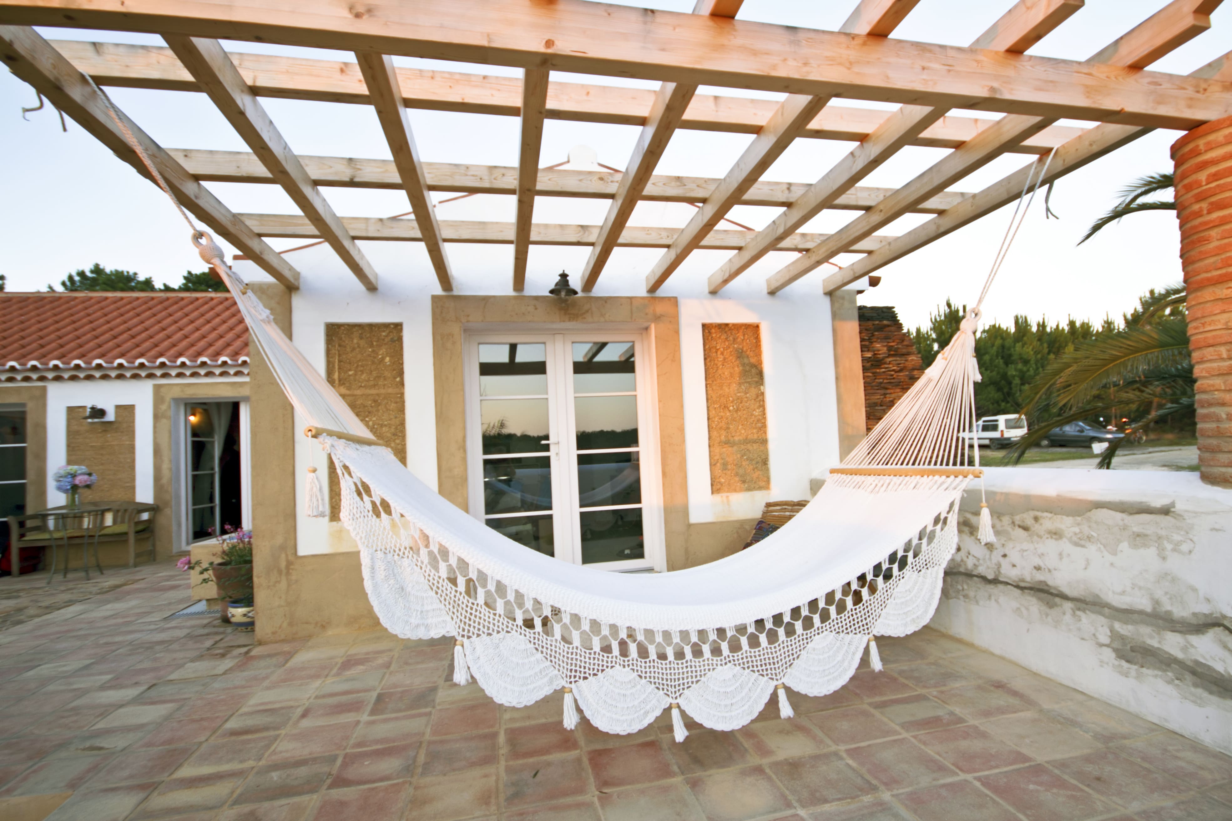 Wooden pergola with intricate white hammock