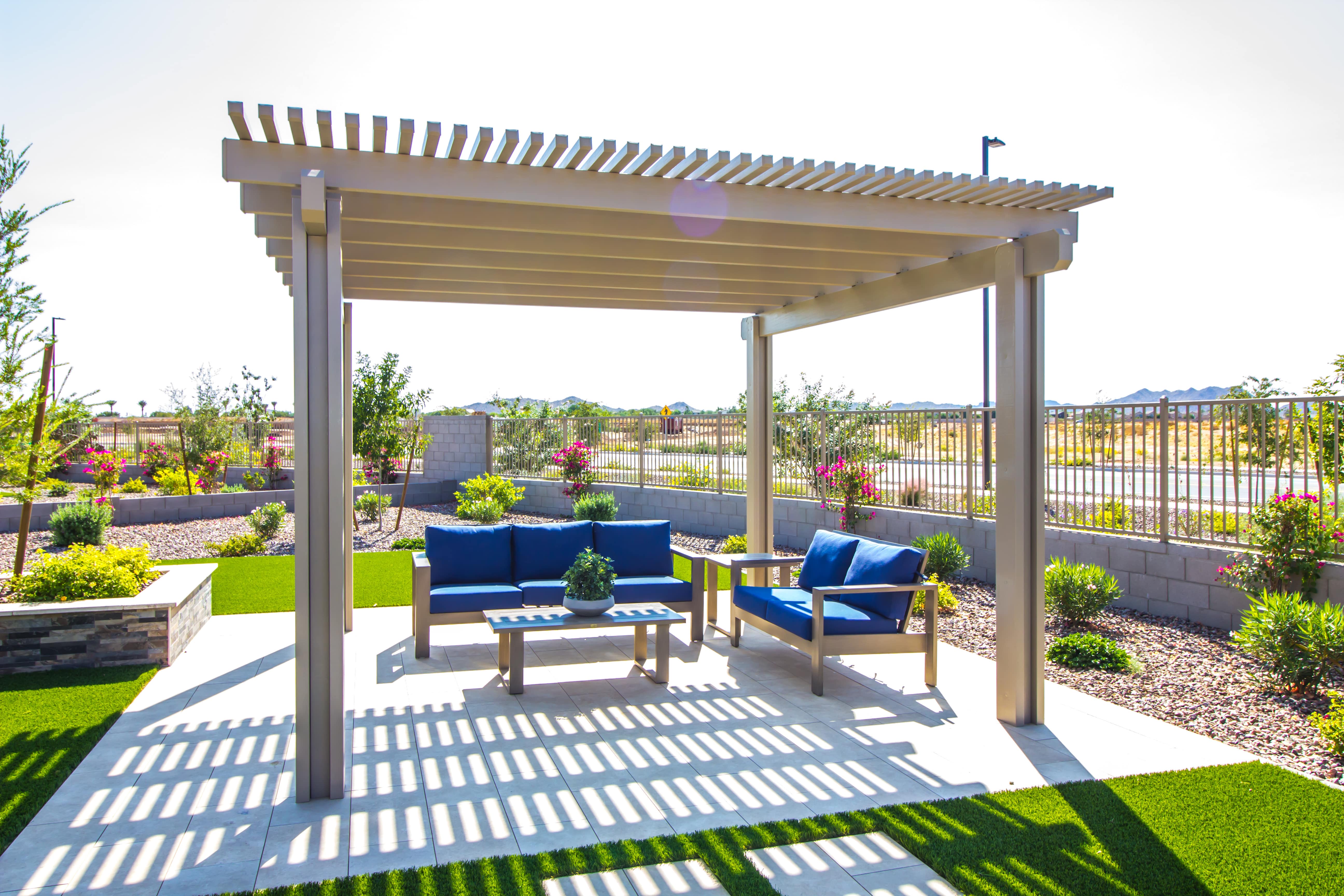 Wooden pergola structure with blue patio furniture set underneath