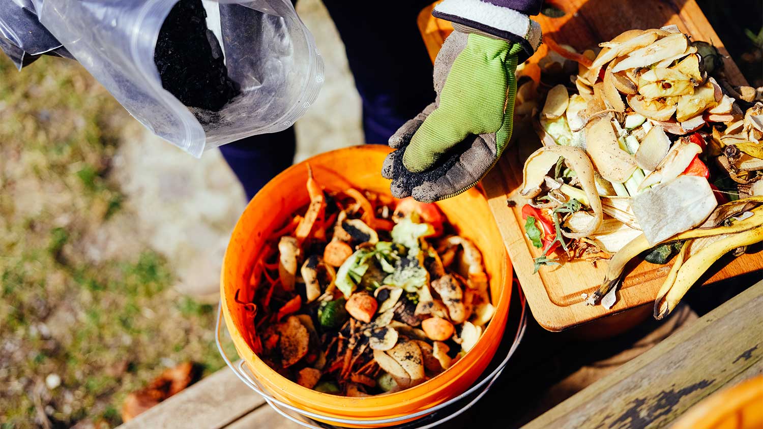 Person using bokashi composting system