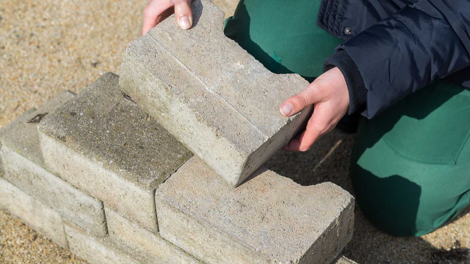 Woman piling up stones on top of each other