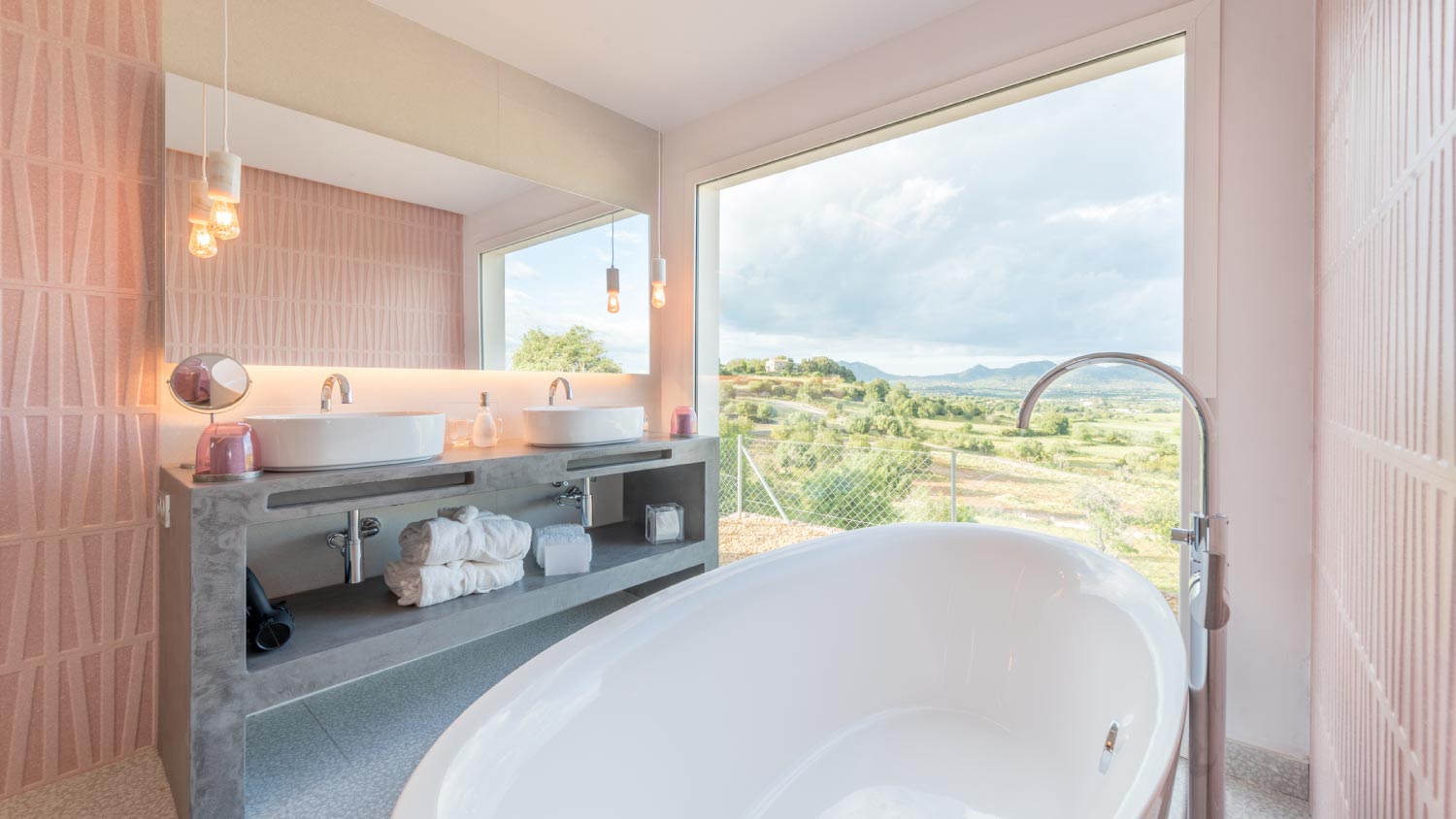 A pink bathroom with a view