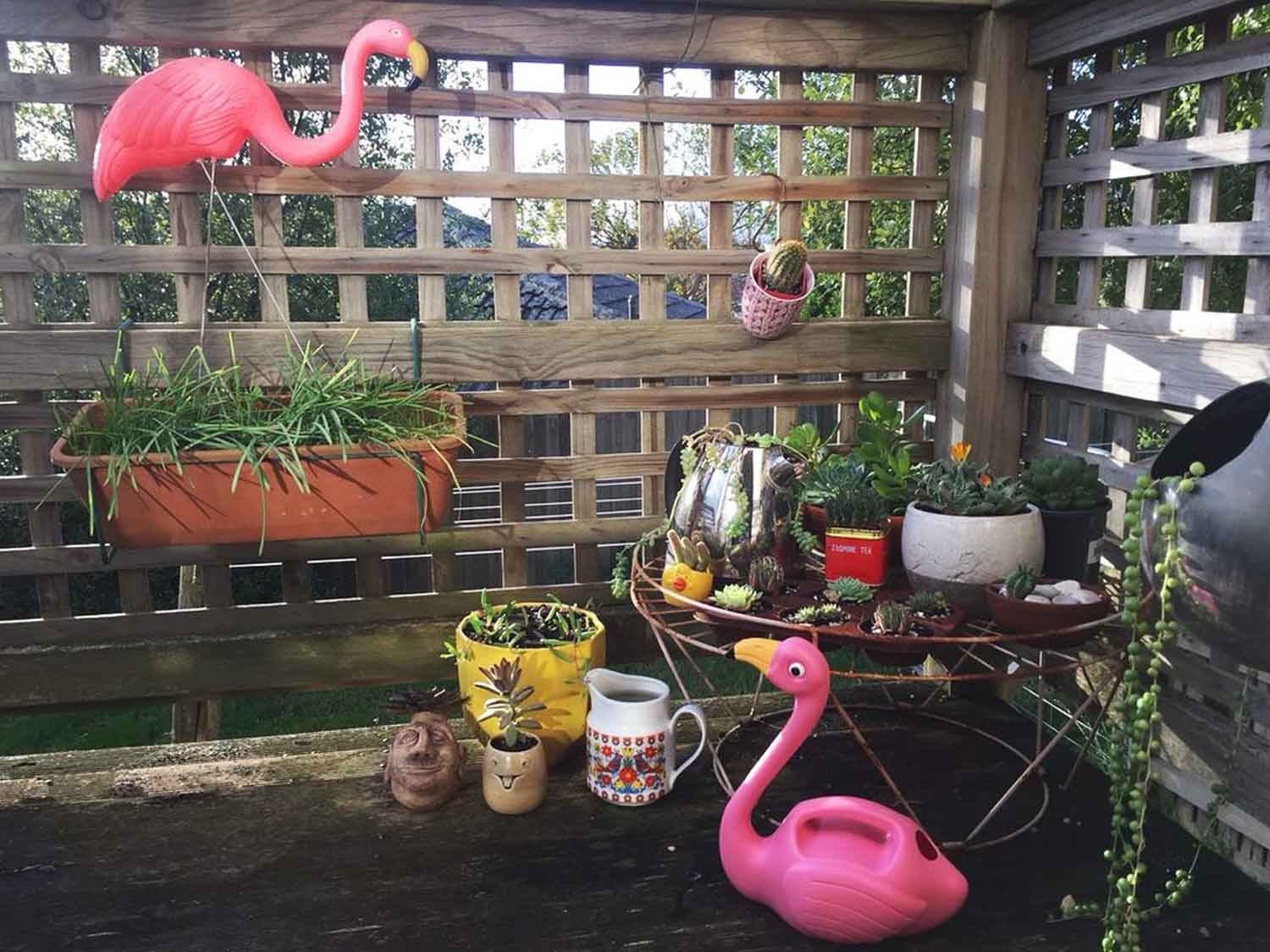 Pink flamingo ornaments in a small garden