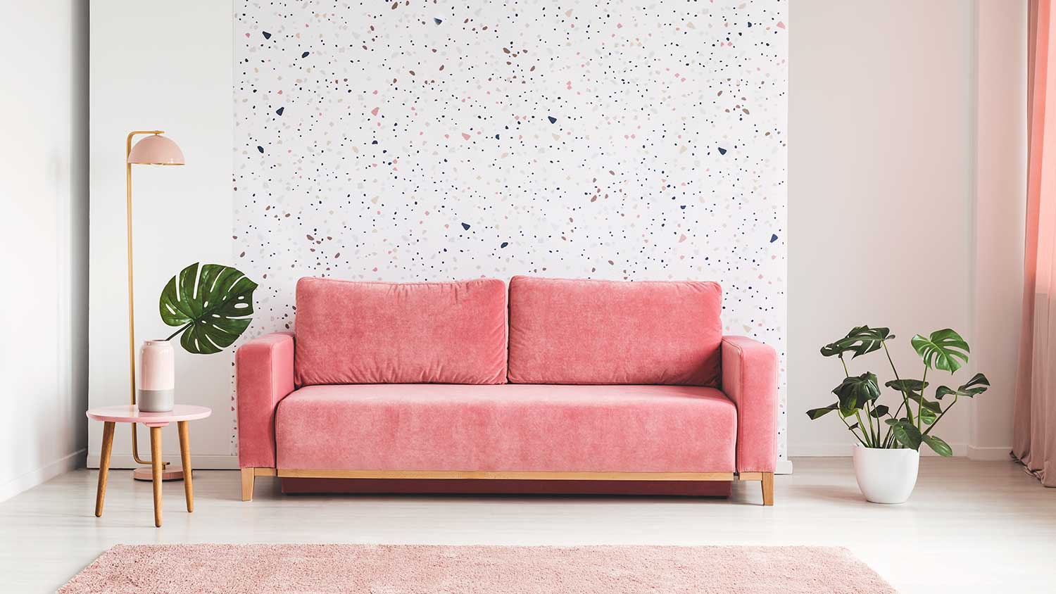 Pink sofa and rug in bright living room