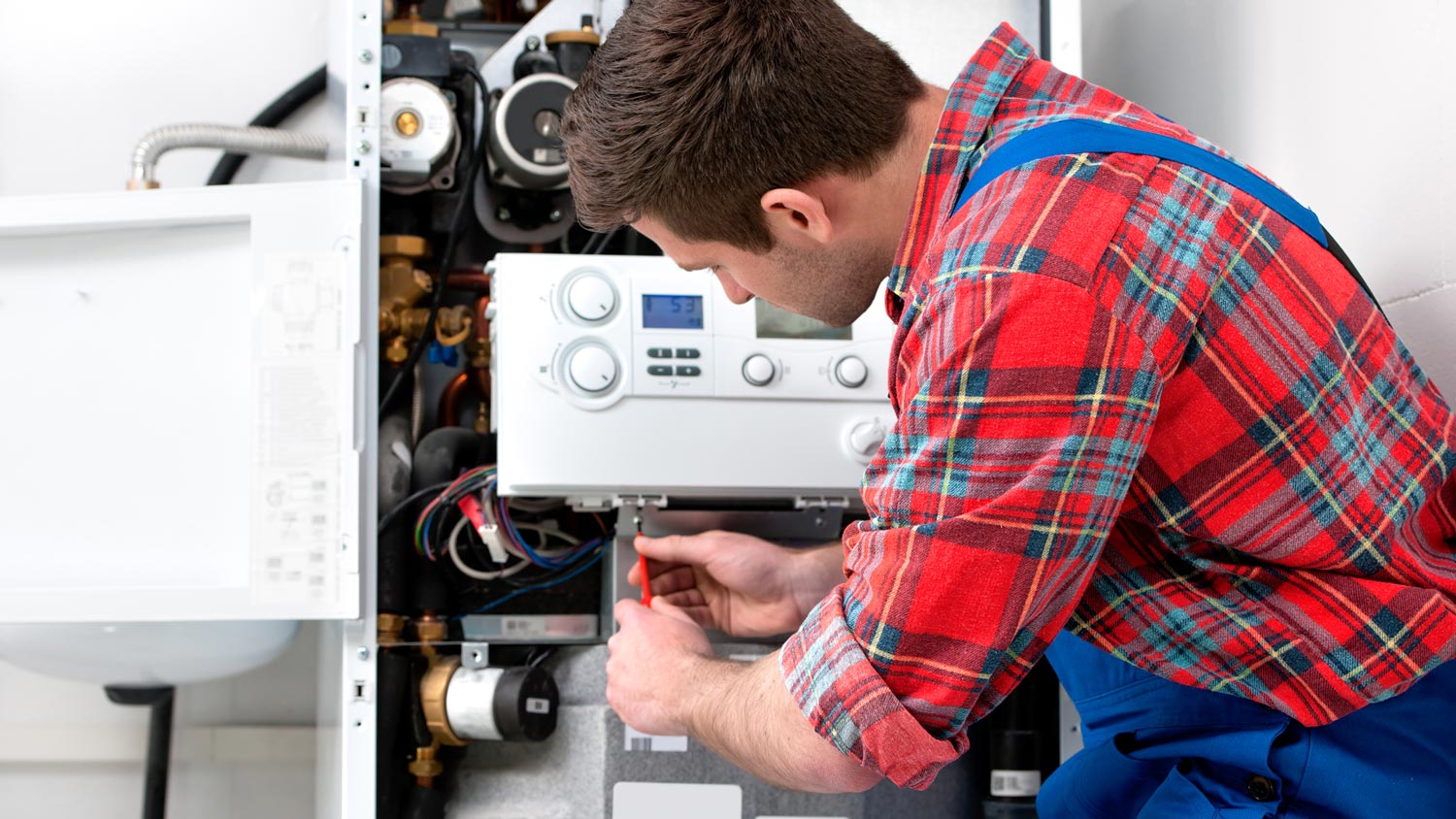 A plumber inspecting a house’s water heater