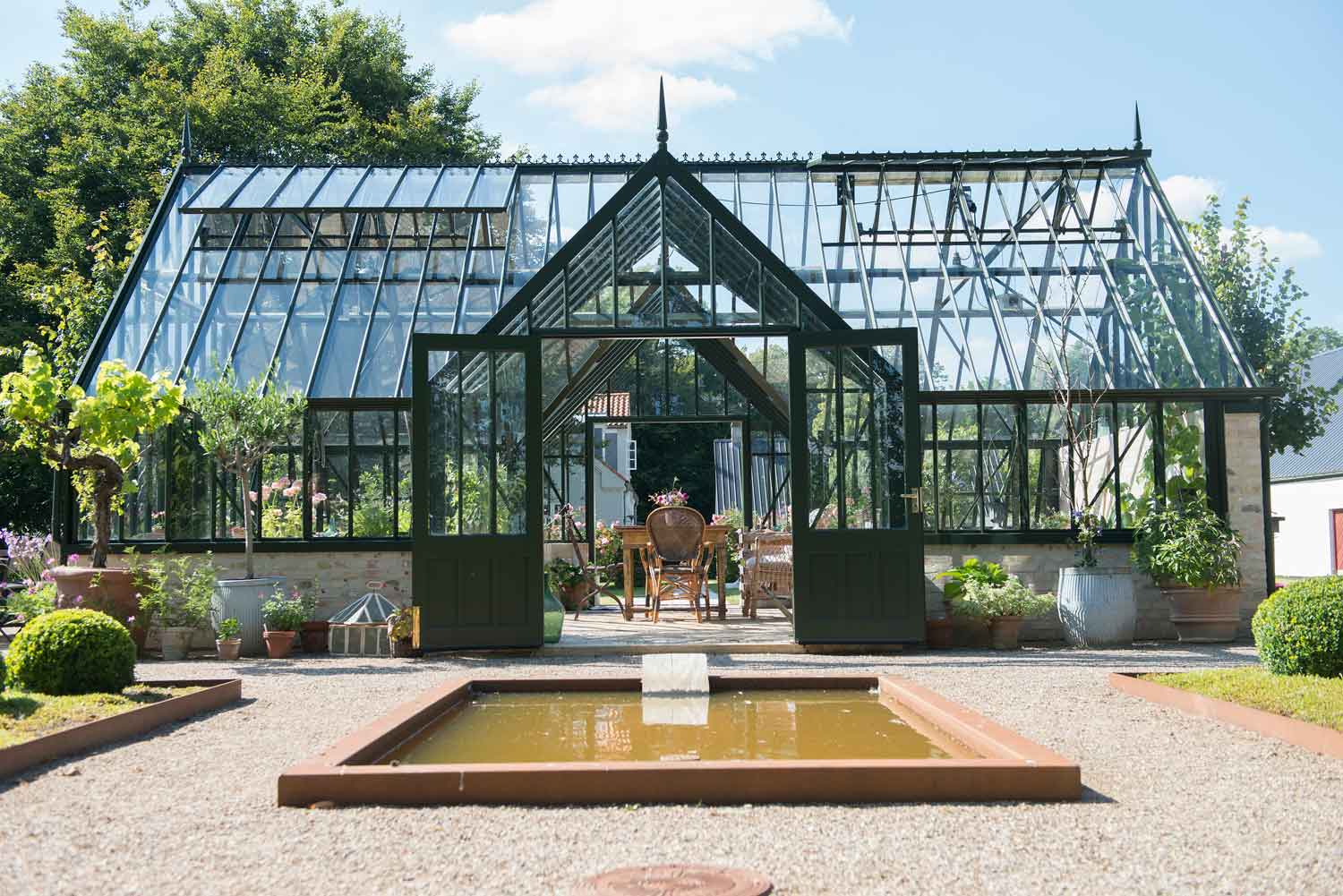 Large greenhouse with pointed roofline entrance