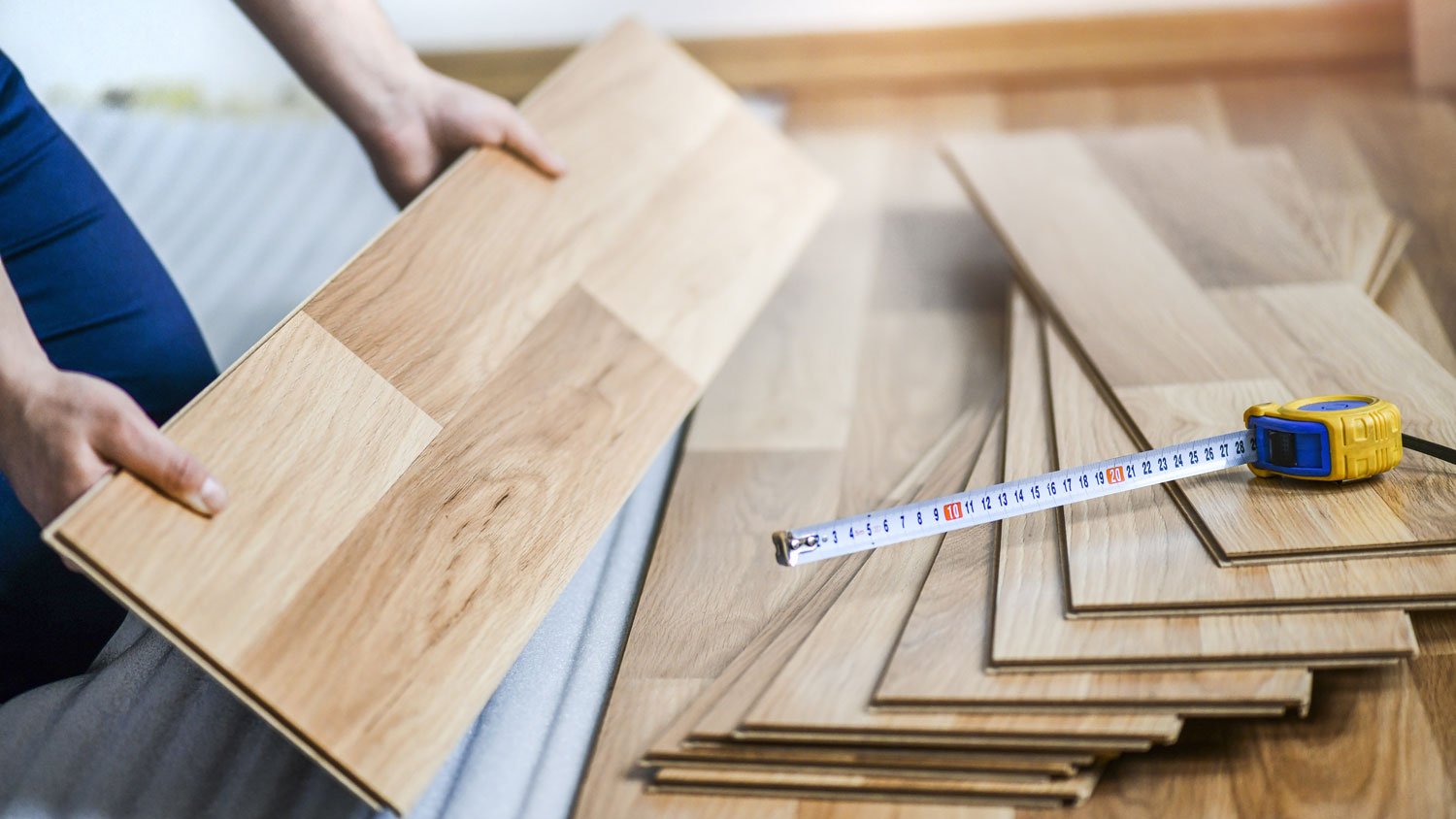 A professional piling up hardwood floor planks