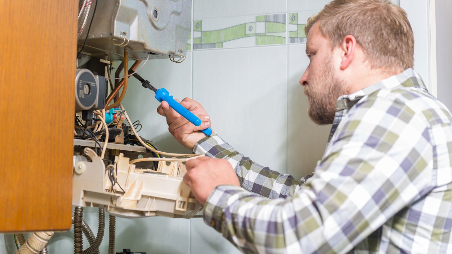 A professional repairing a furnace