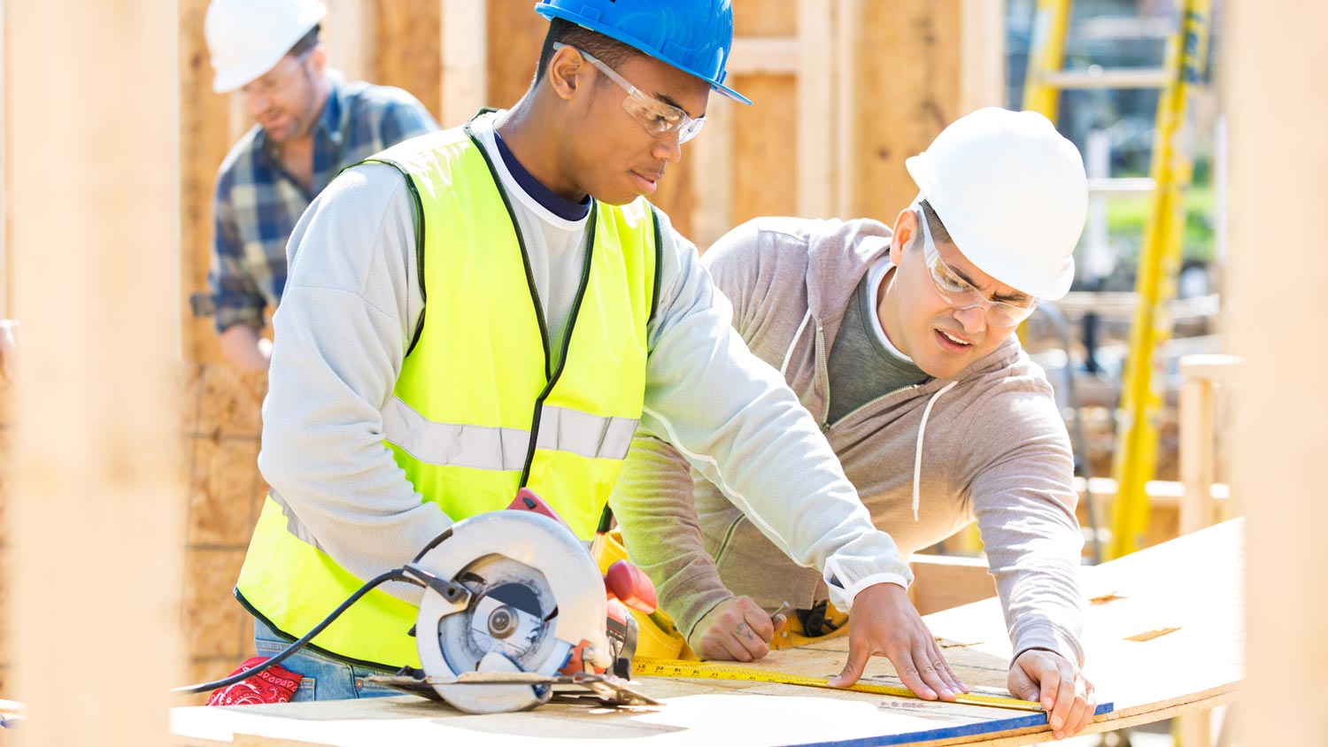 Two professionals overlooking the blueprints of a house