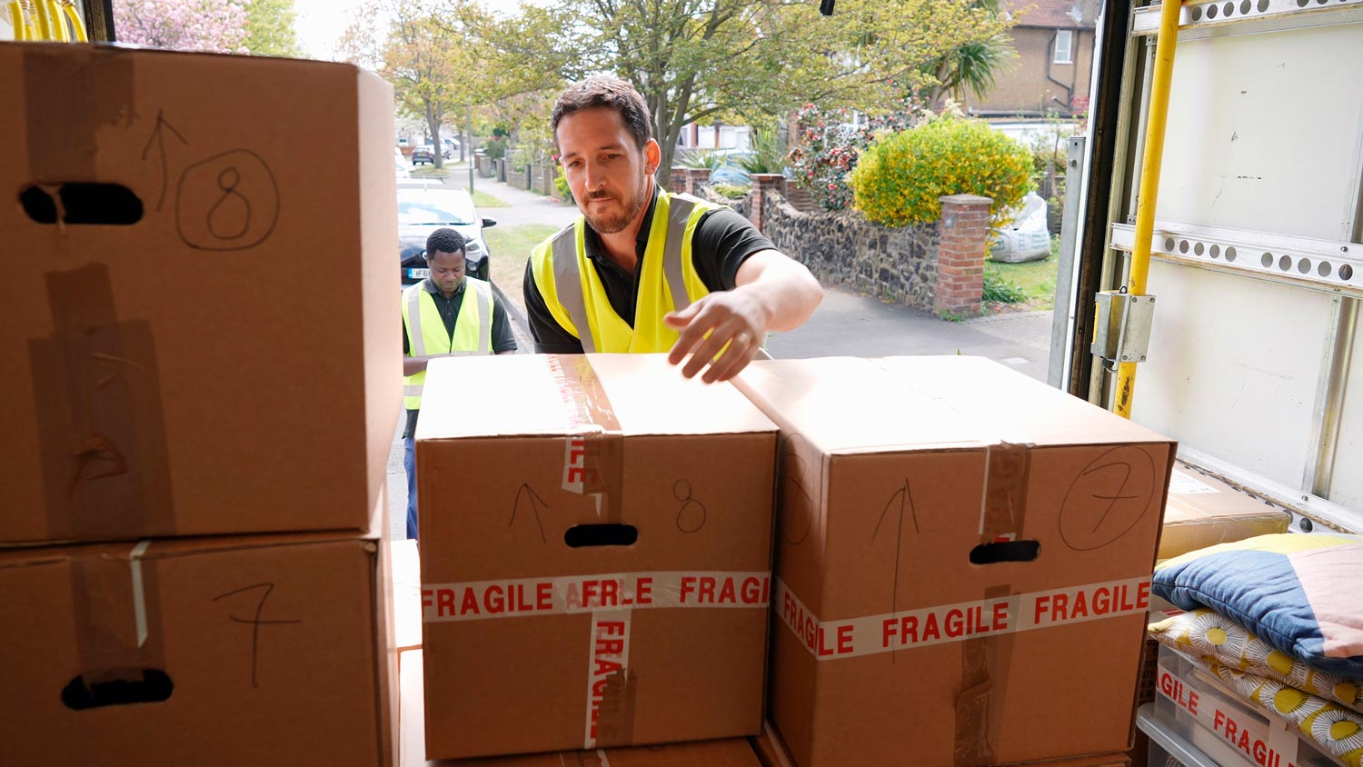 Professionals unloading boxes from truck