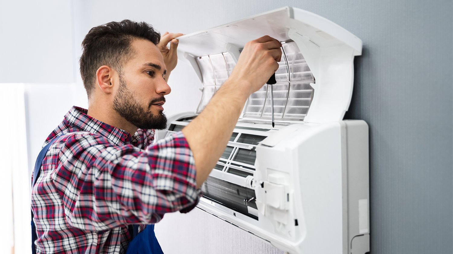 repairman repairing air conditioner