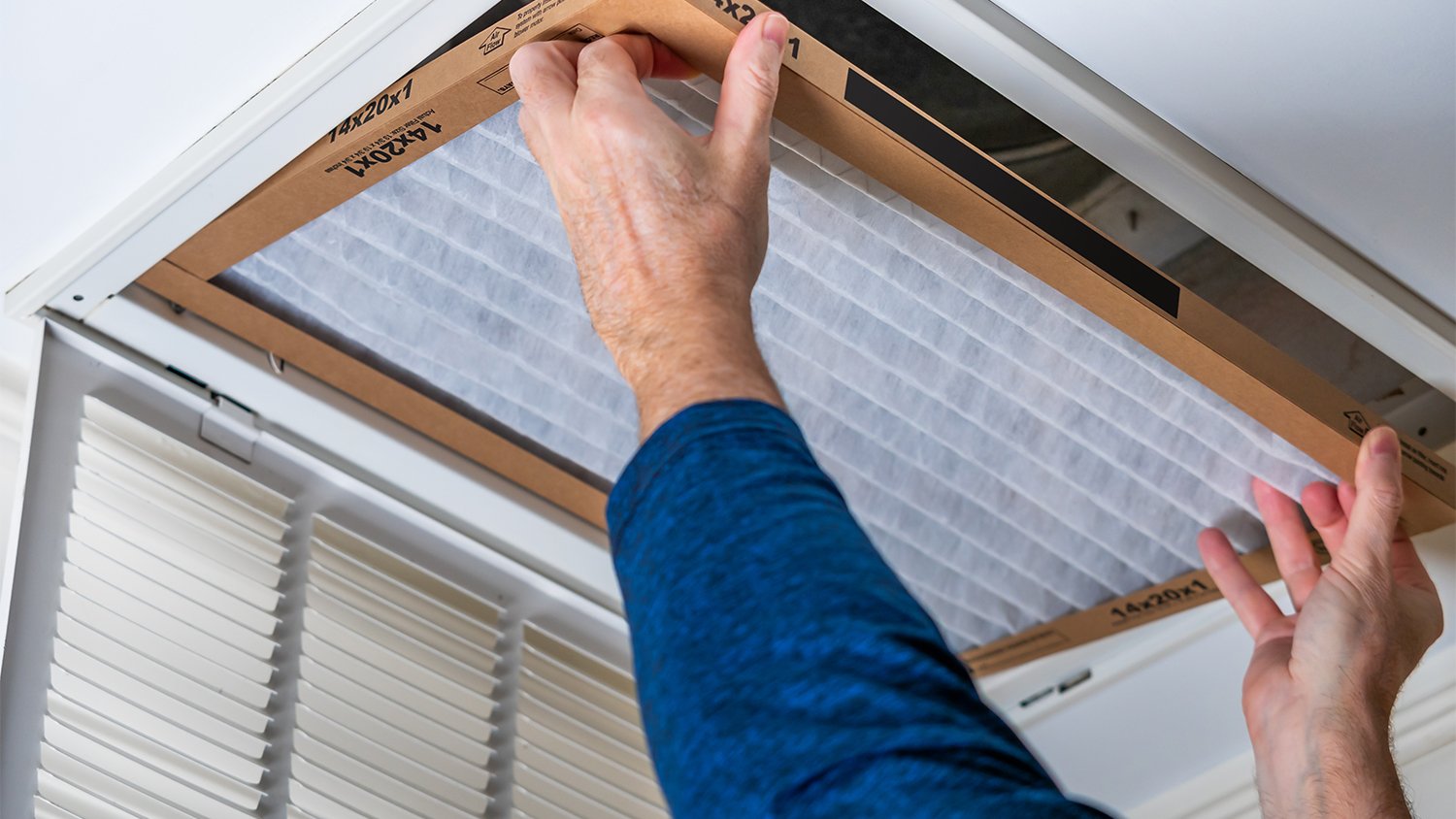 man replacing hvac air filter