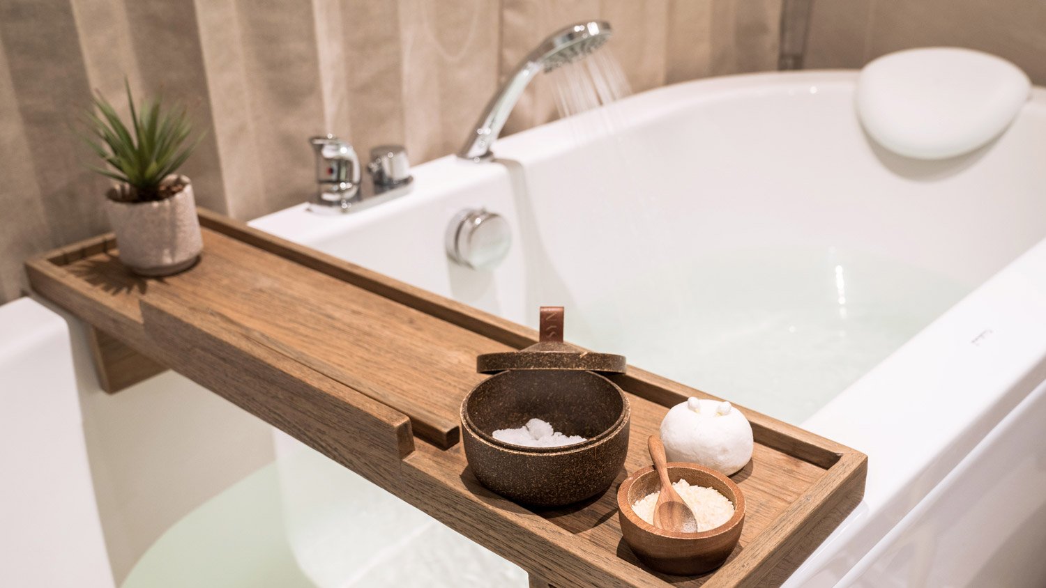 Running water into a deep, modern bathtub