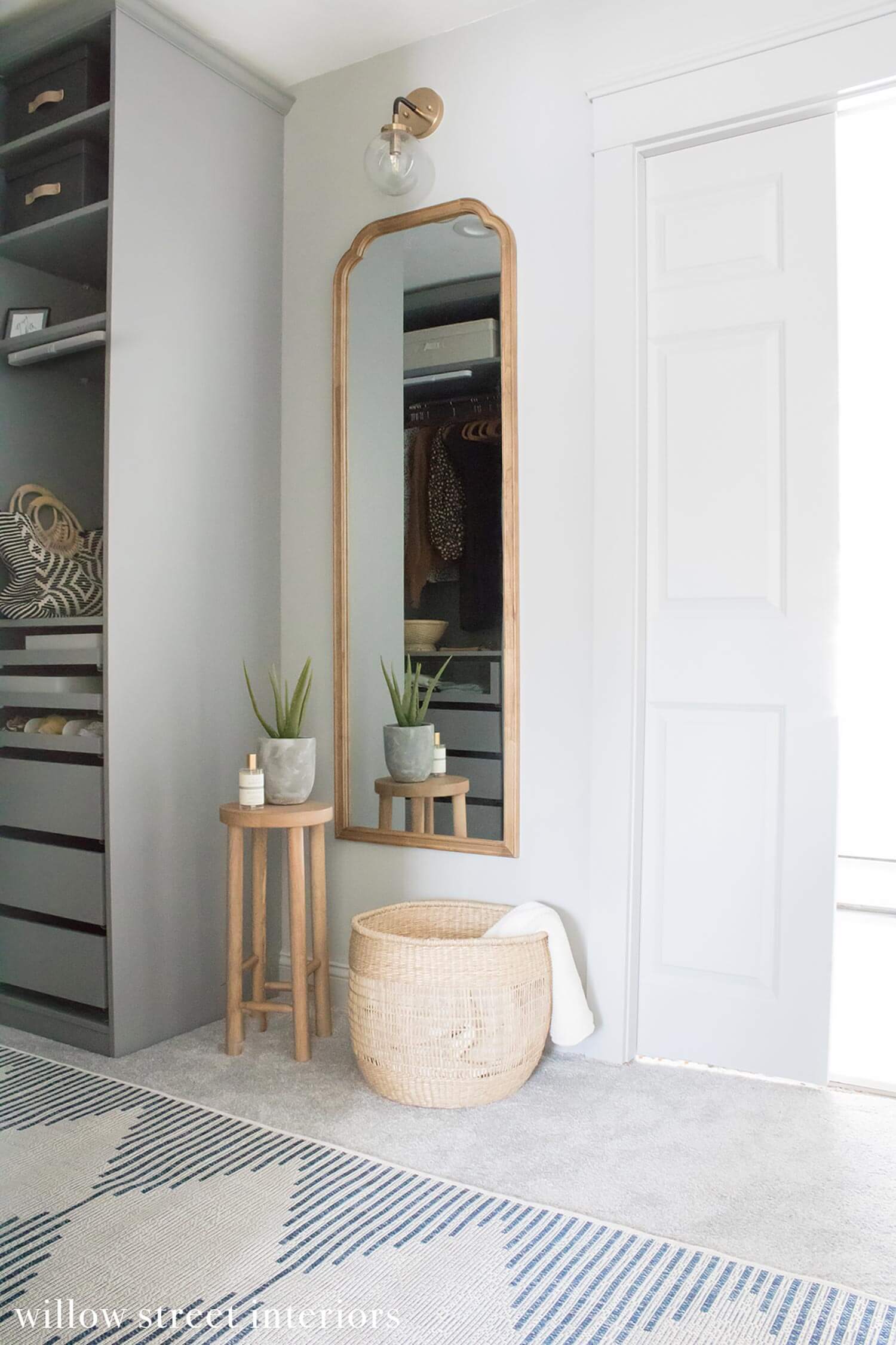 A metallic sconce above a mirror