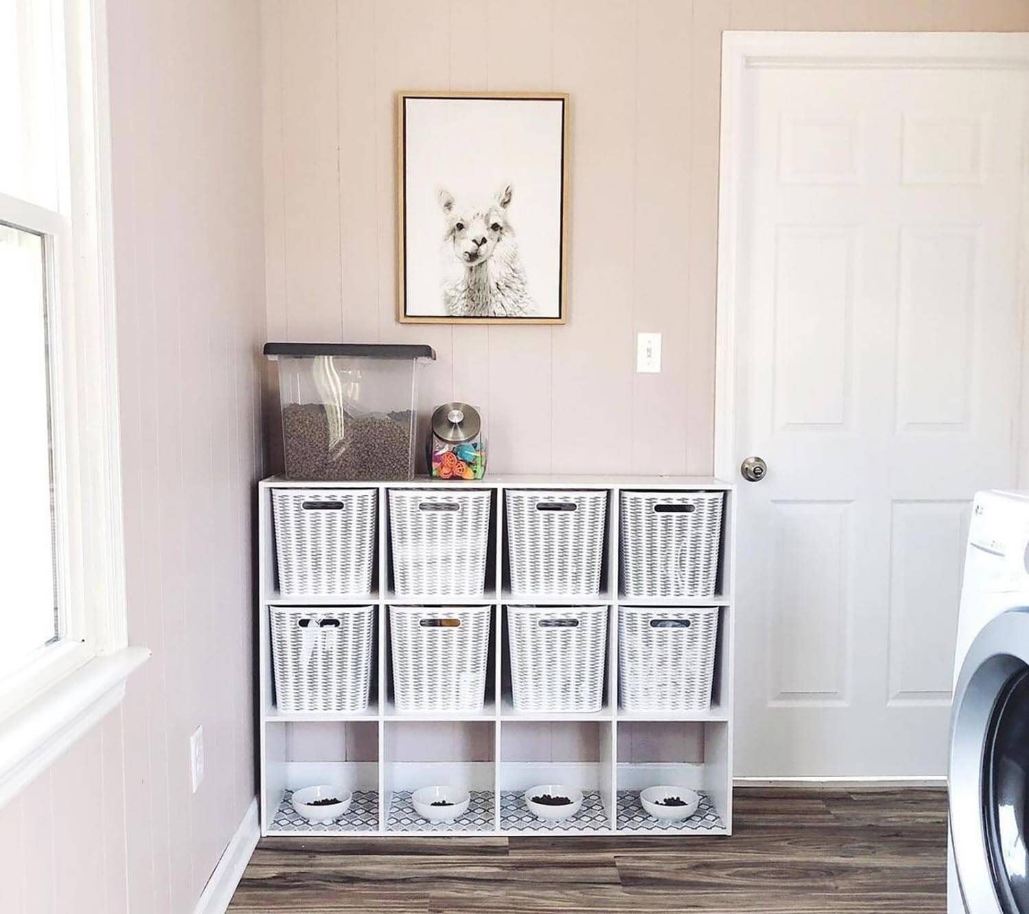 A shelving unit with four feeding cubbies for cats