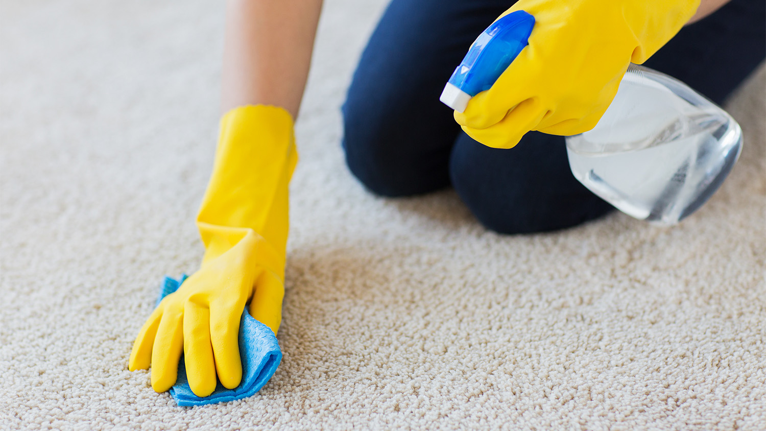 woman spraying carpet cleaner  