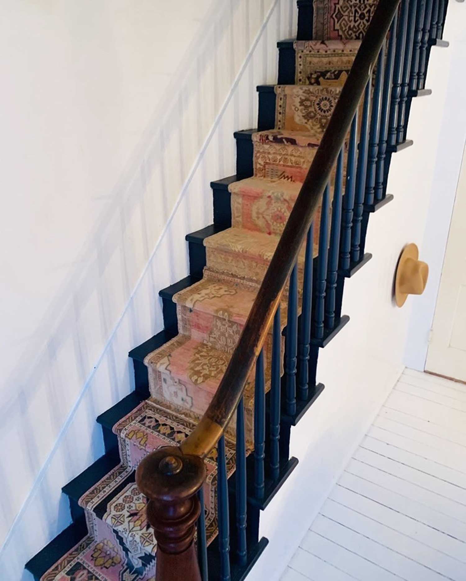 Home staircase with pink runner rug