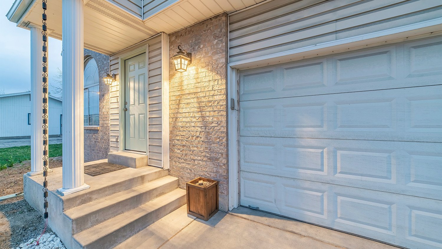 stone home with rain chain in front 