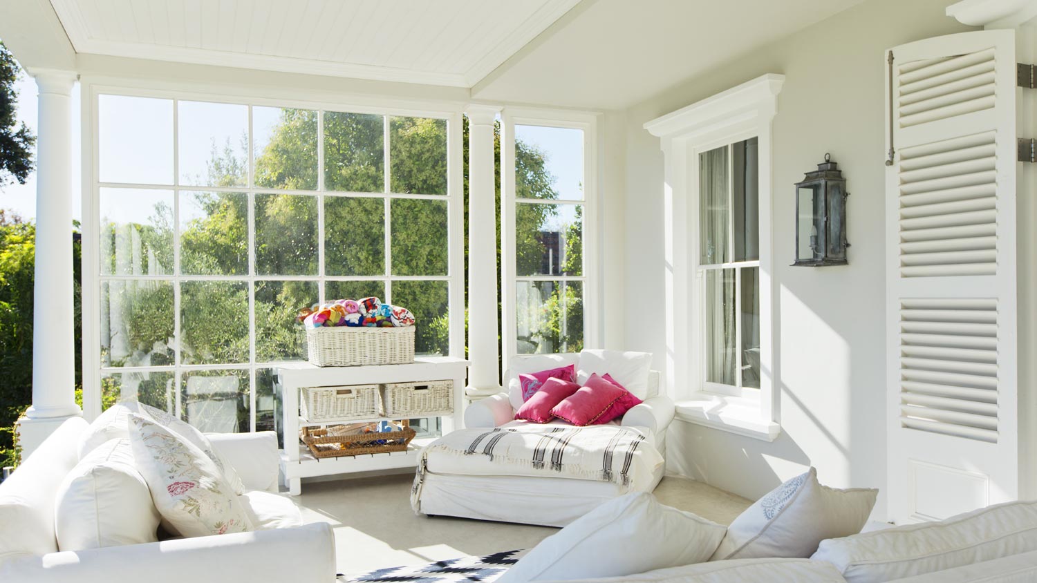 A house’s sunroom with a lounge area