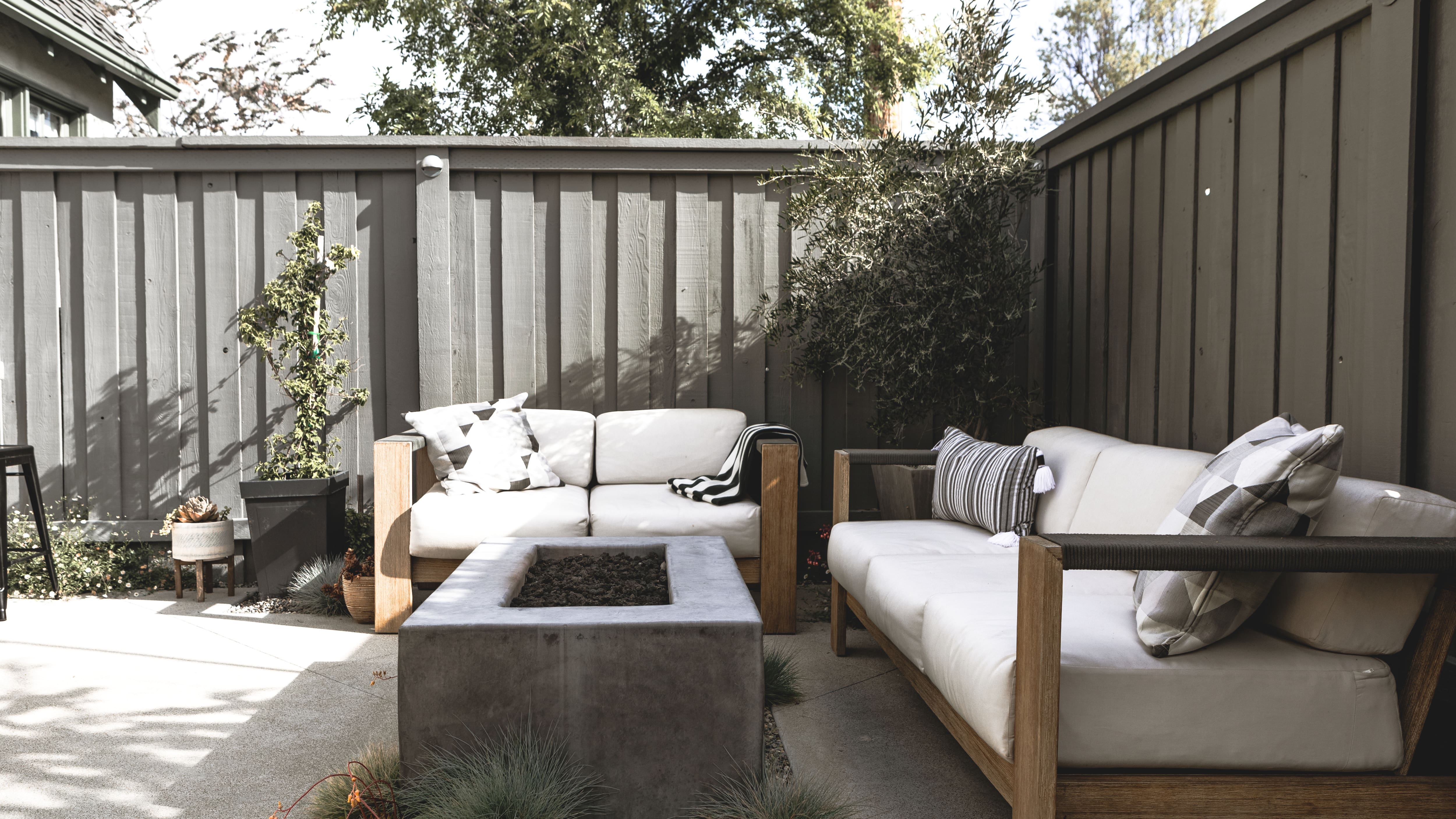 Teak wood couch and loveseat around fireplace