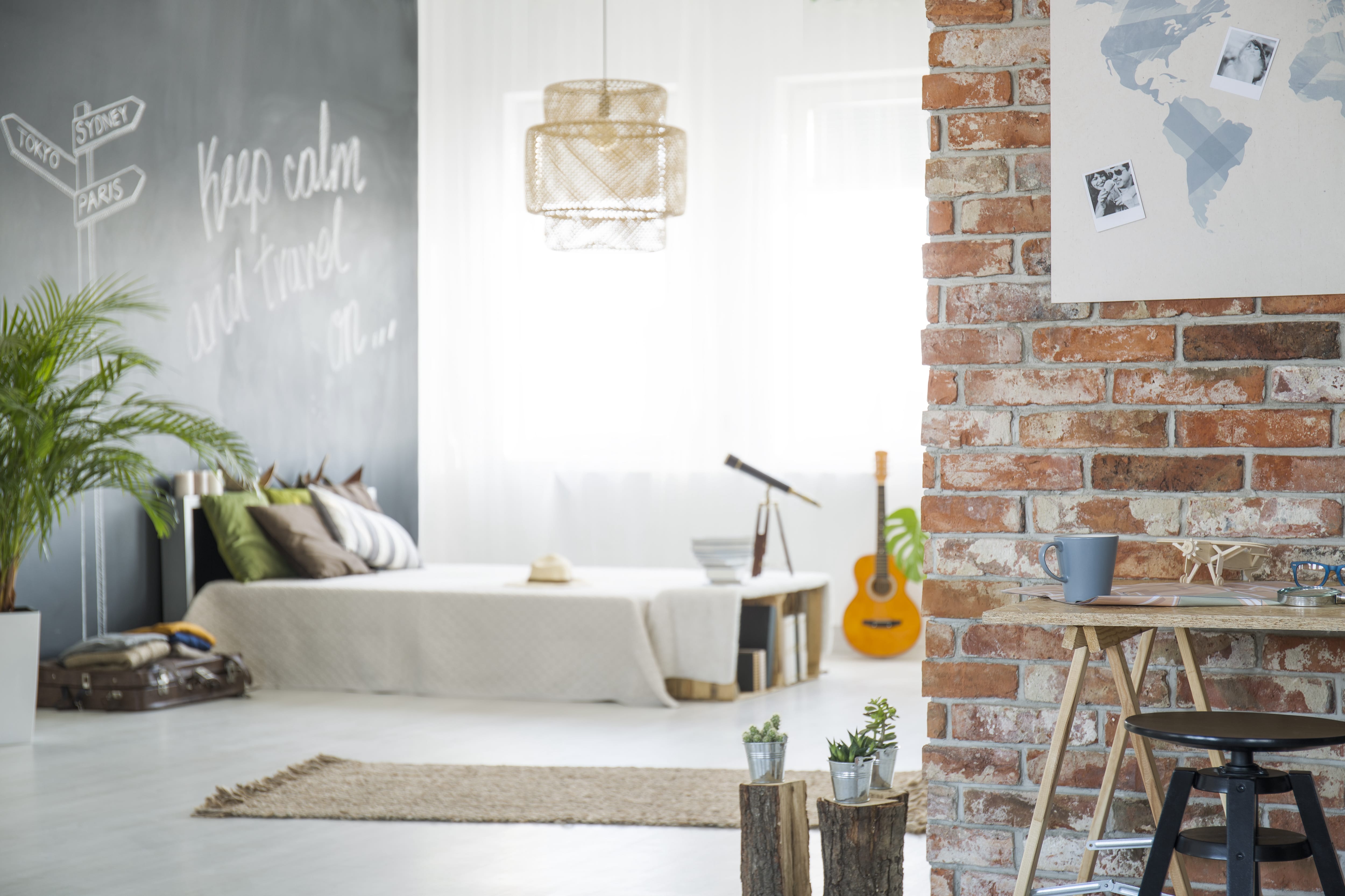 Travel-themed bedroom with chalkboard wall