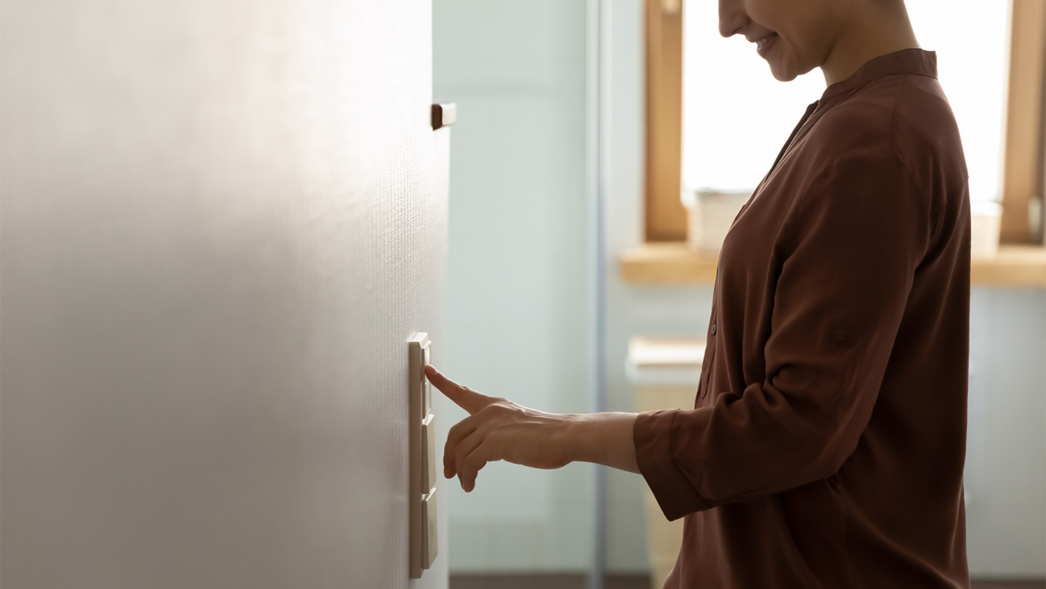 Woman turning room lights off