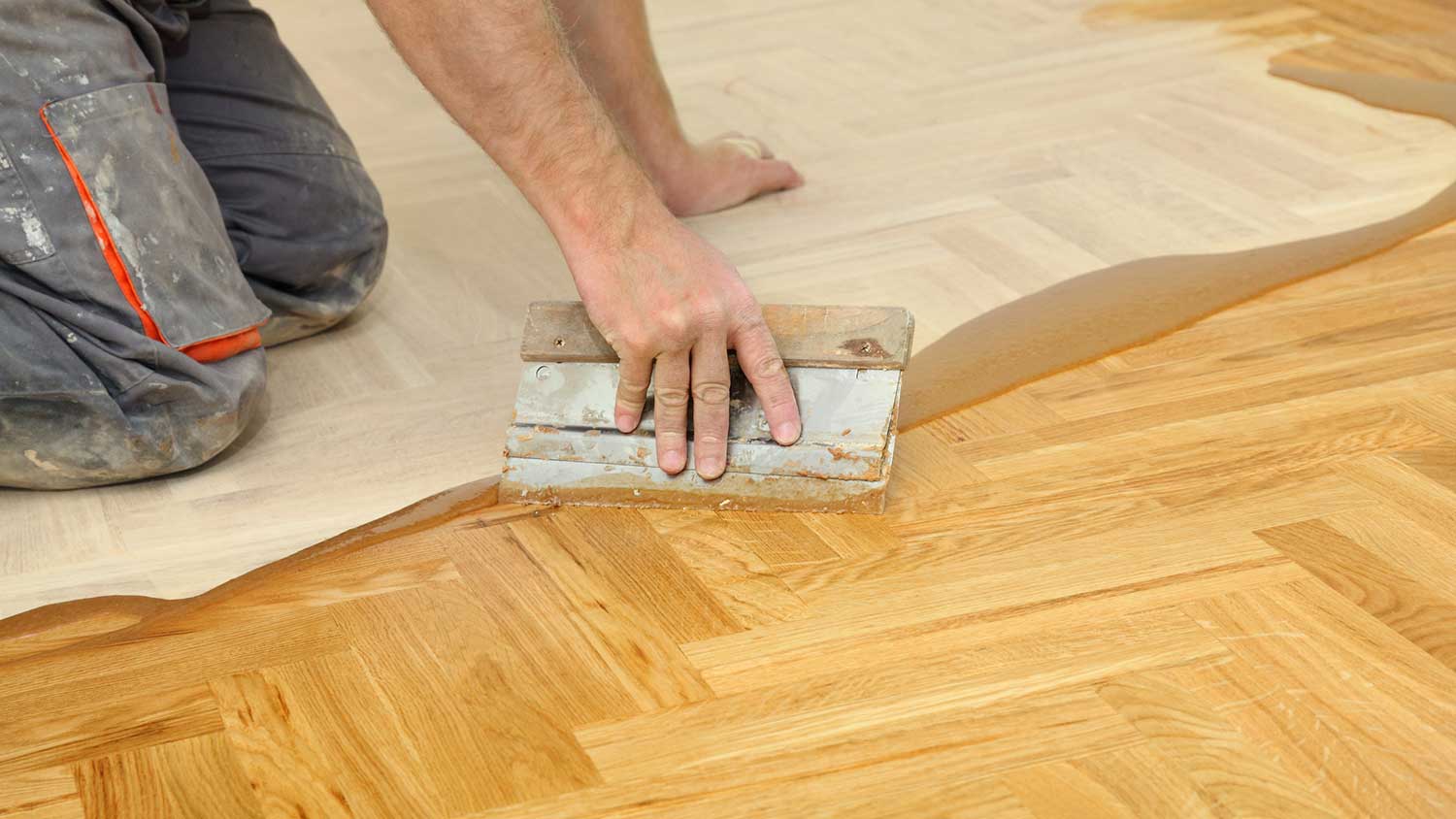Applying varnish to oak parquet floor