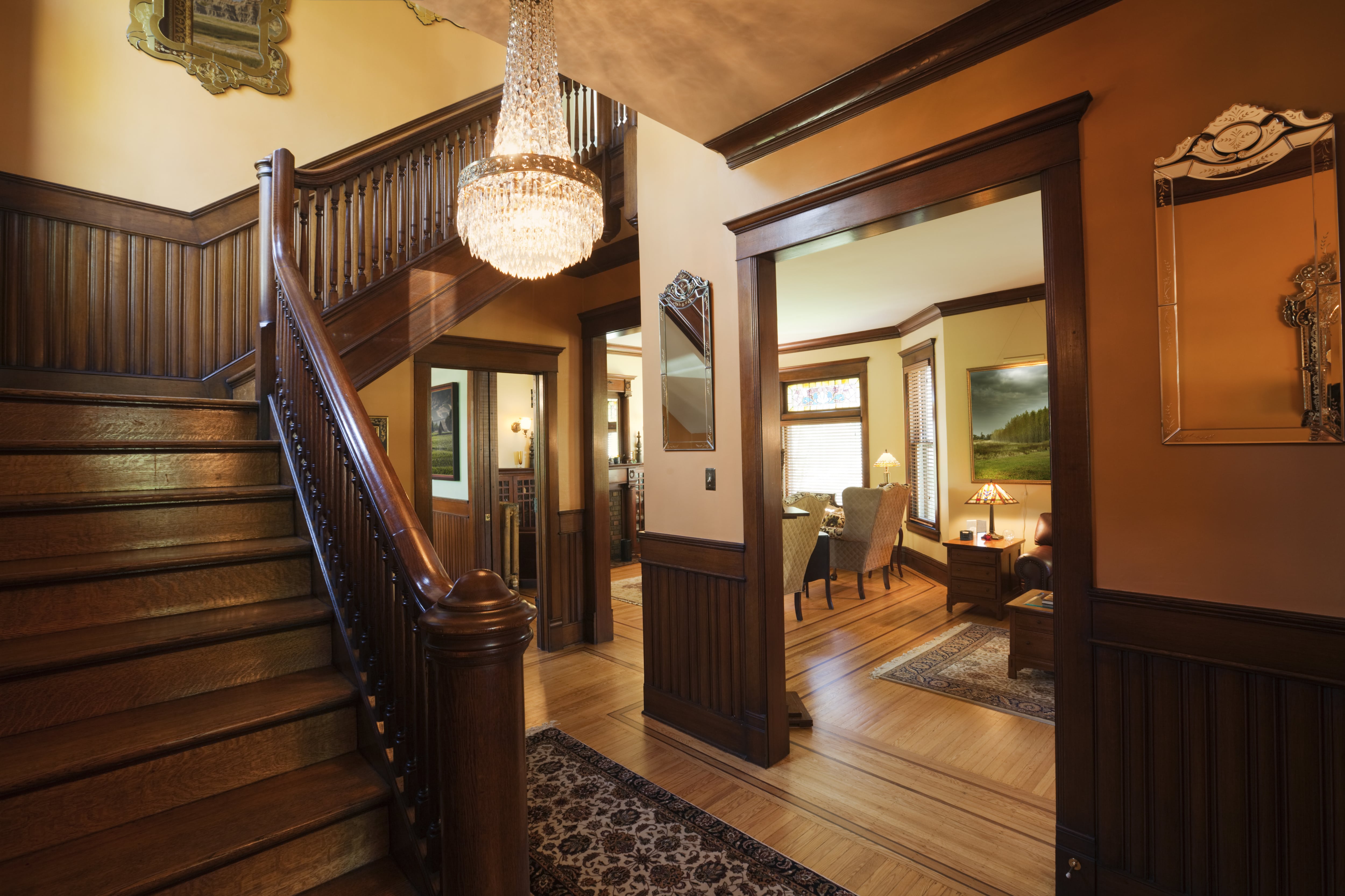 Entryway of Victorian home lined with mahogany wainscoting  